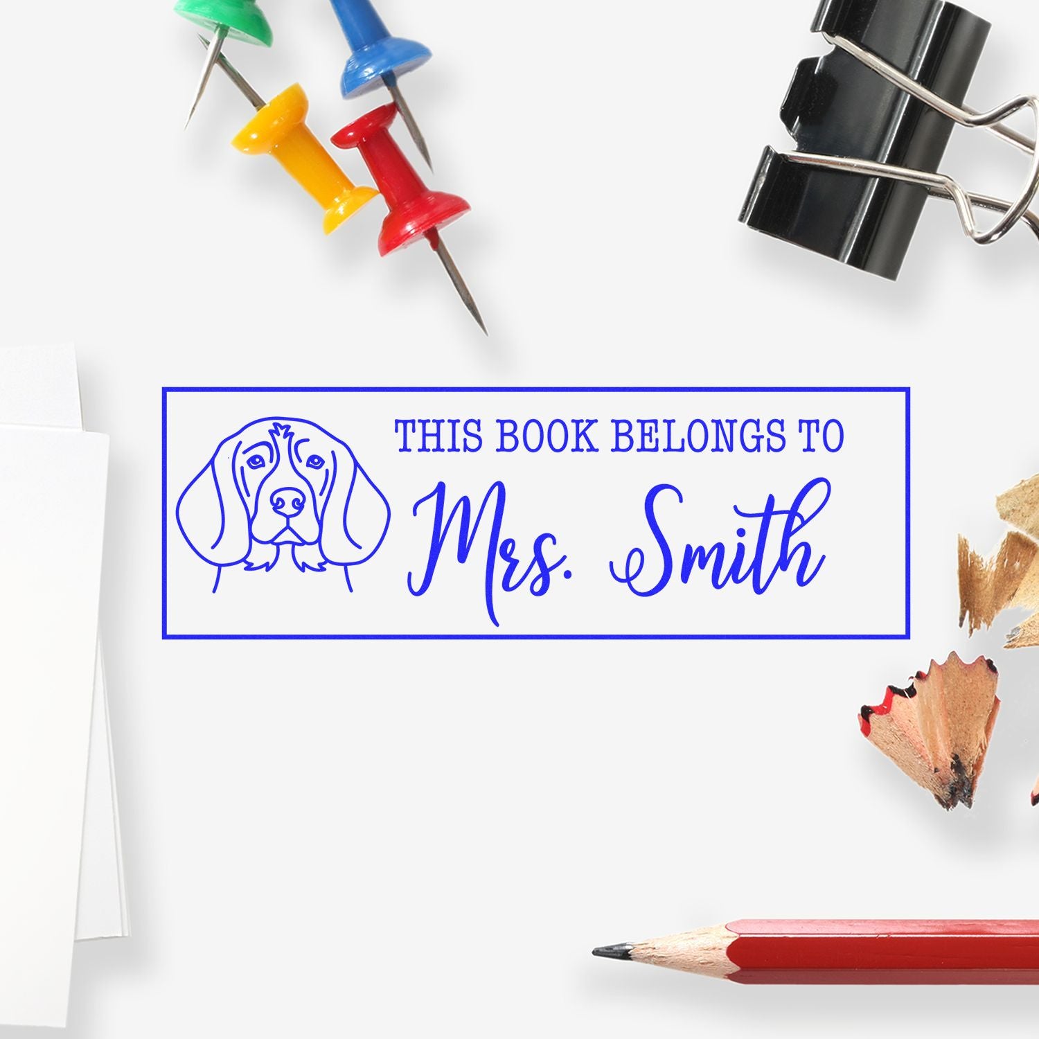 Personalized rubber stamp for books with dog design and This Book Belongs to Mrs. Smith text.