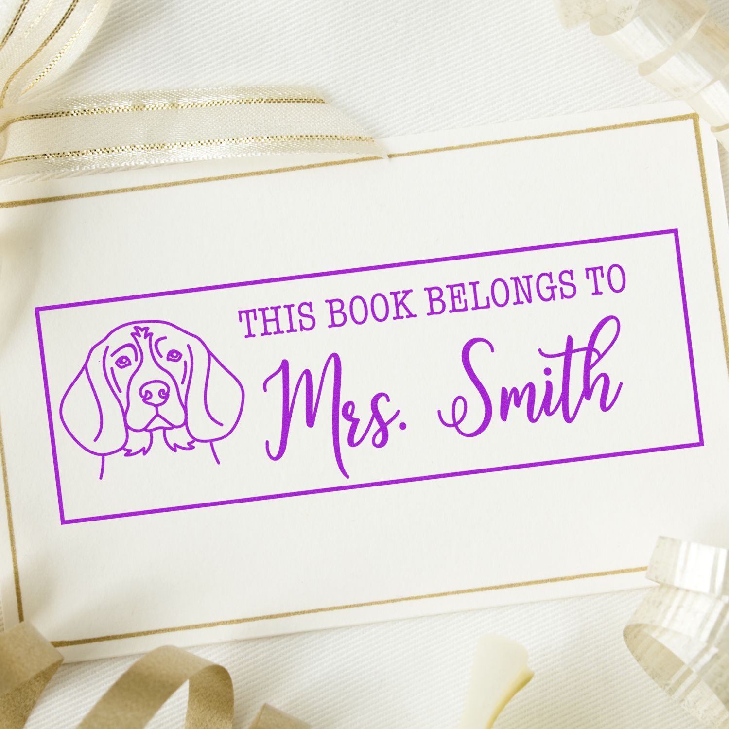 Personalized dog book stamp reading This Book Belongs to Mrs. Smith for custom library ownership labels.