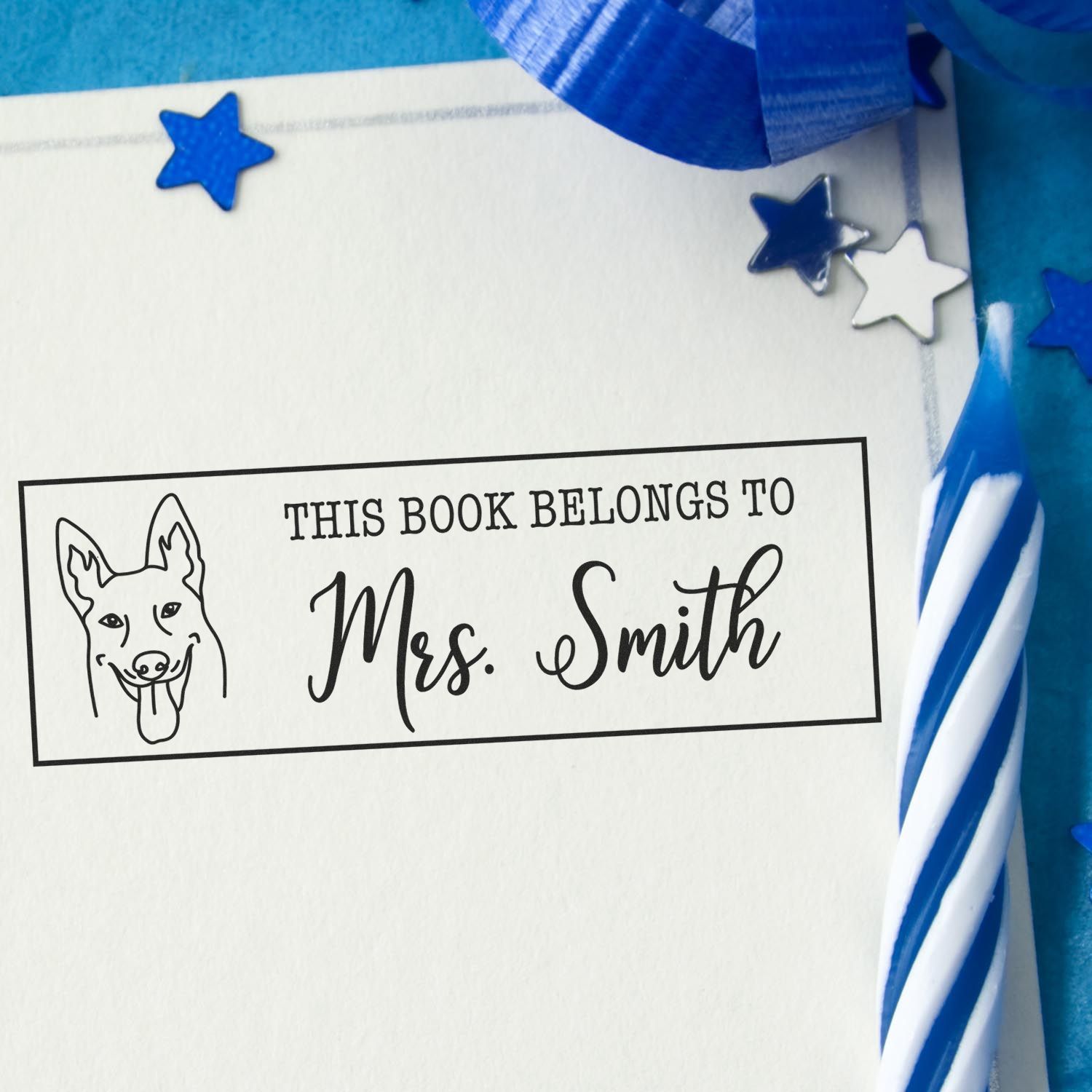 Personalized rubber book stamp with dog illustration and This Book Belongs to Mrs. Smith for custom book plates and library books.