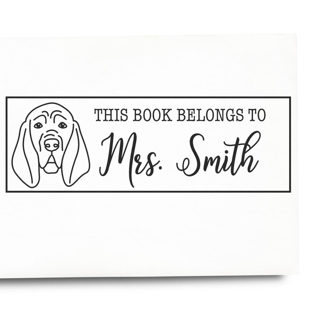 Personalized rubber book stamp with dog illustration and This Book Belongs to Mrs. Smith for library books.
