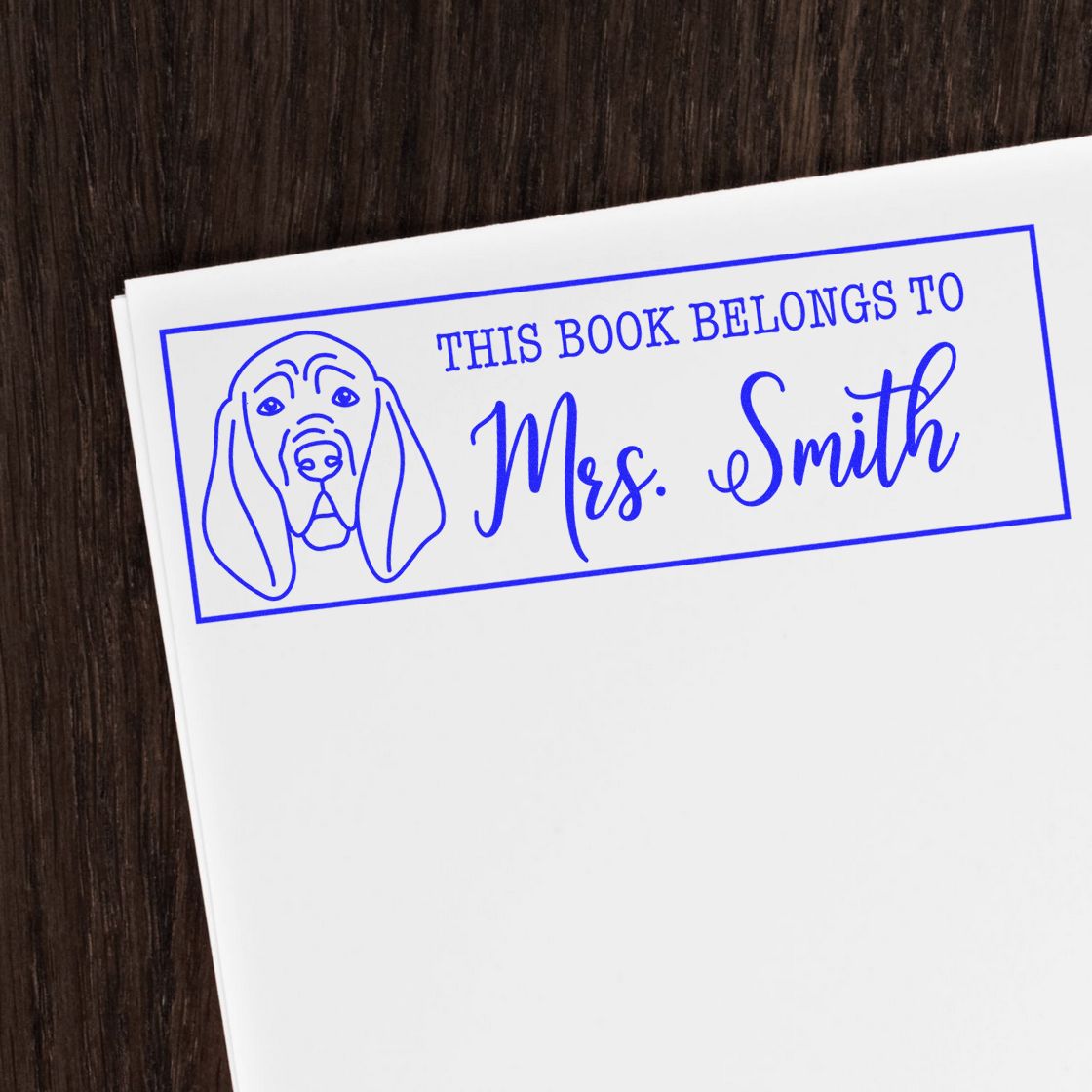 Personalized book stamp with dog illustration and This Book Belongs to Mrs. Smith custom rubber stamp for library books.