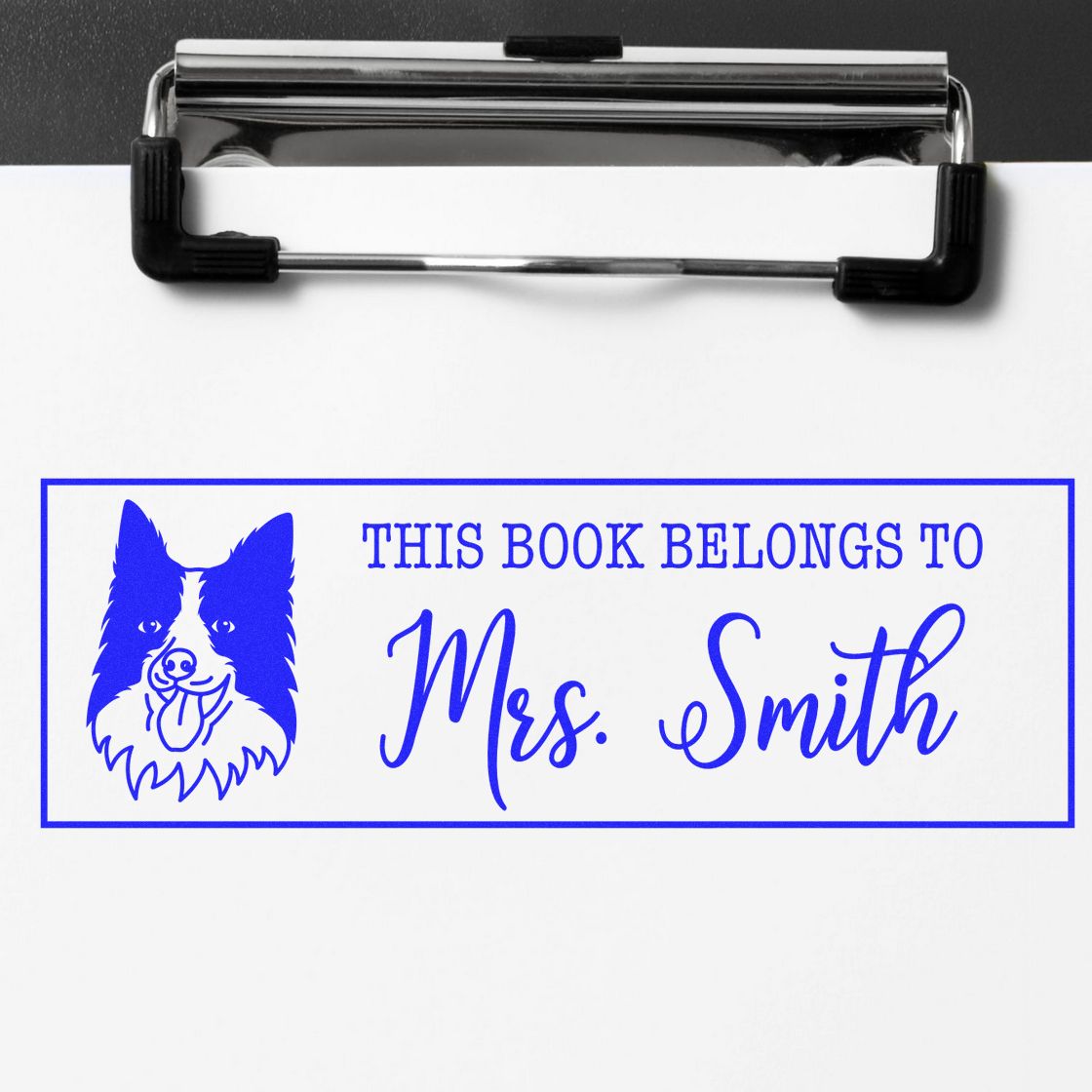 Custom book rubber stamp with dog design and This Book Belongs to Mrs. Smith for library identification.