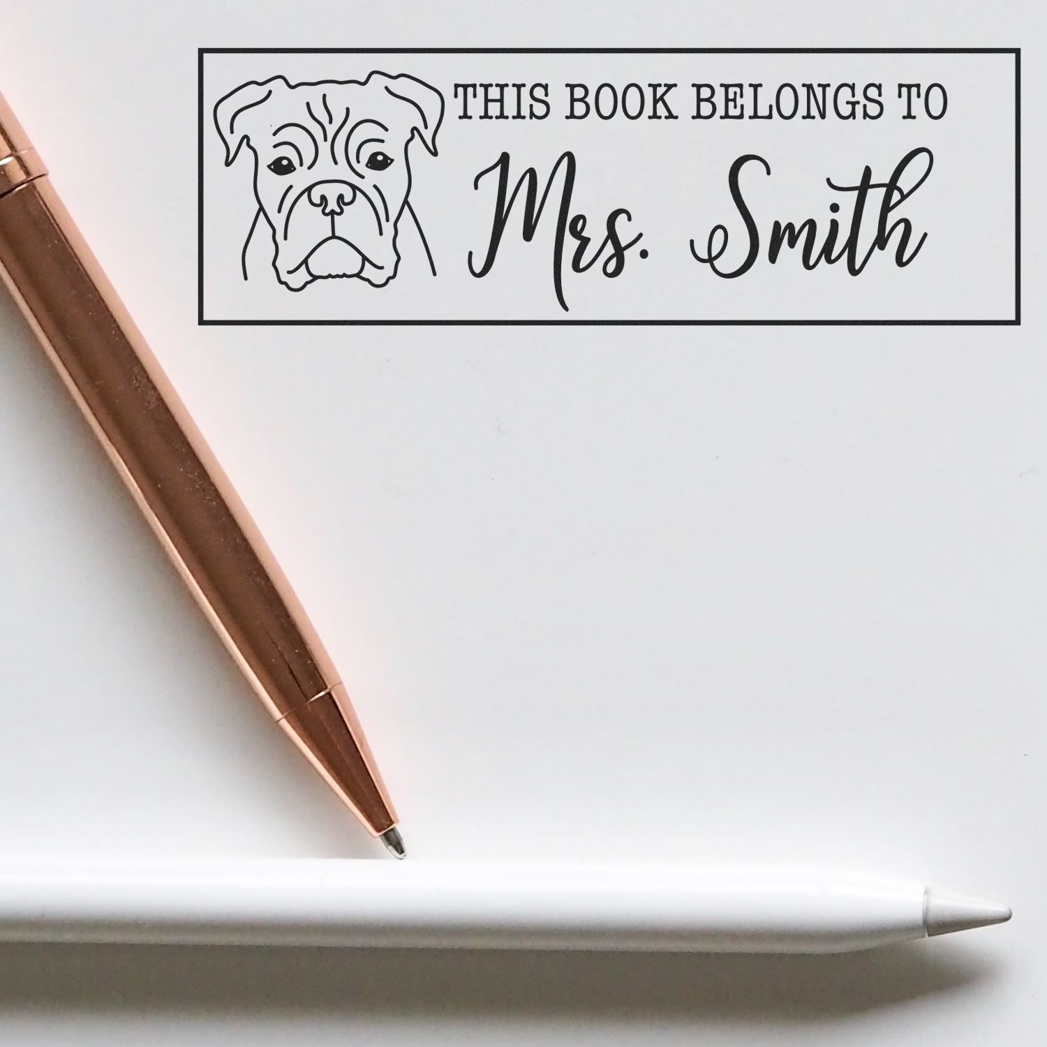 Custom dog book stamp with This book belongs to Mrs. Smith for personalized library books and teacher gifts.