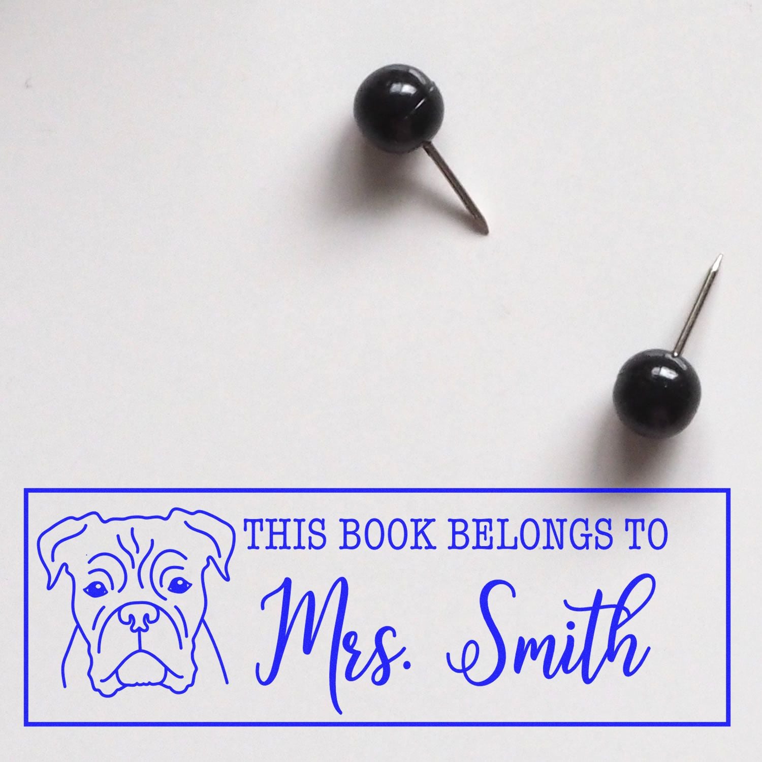 Personalized rubber stamp with dog illustration reading This Book Belongs to Mrs. Smith for books and libraries.
