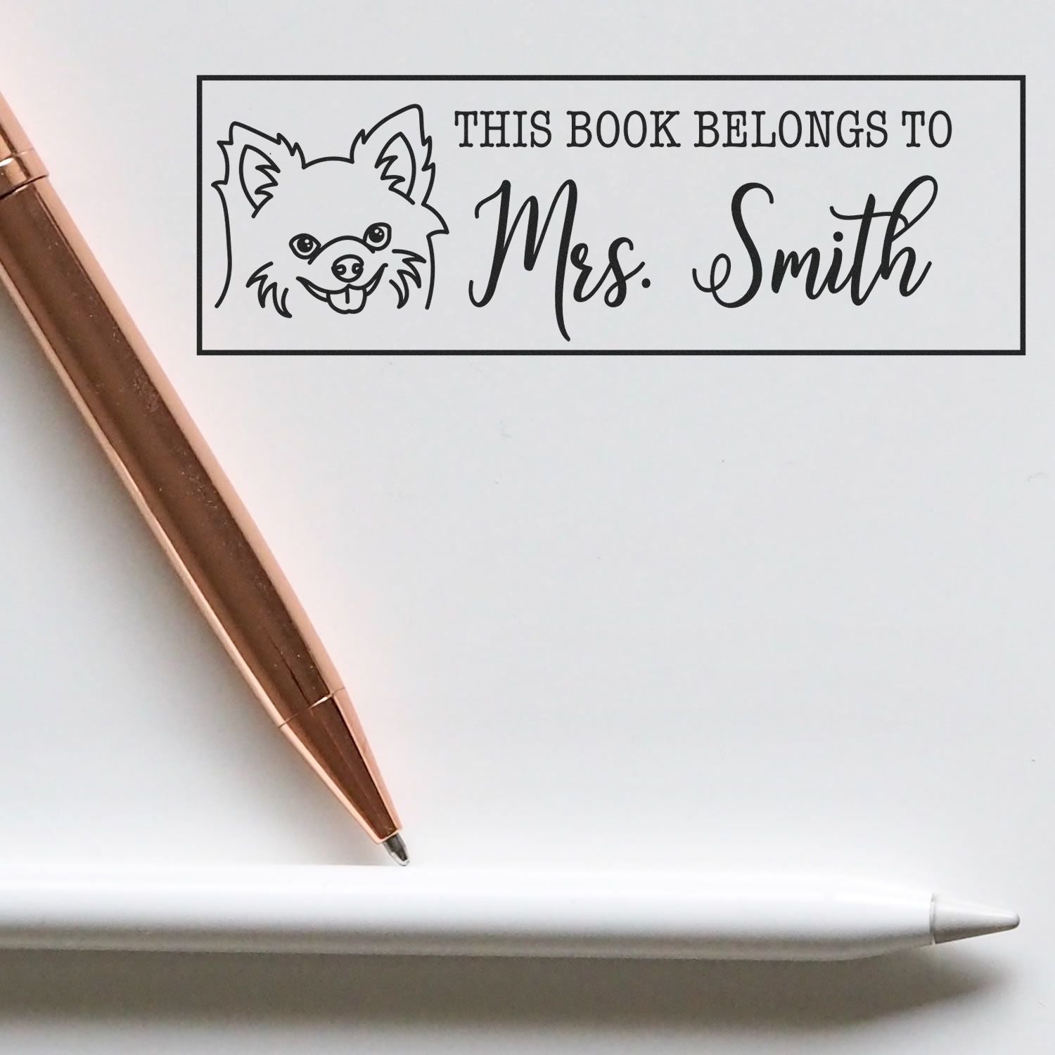 Personalized rubber stamp reading This Book Belongs to Mrs. Smith with dog design for books, labels, and teacher gifts.