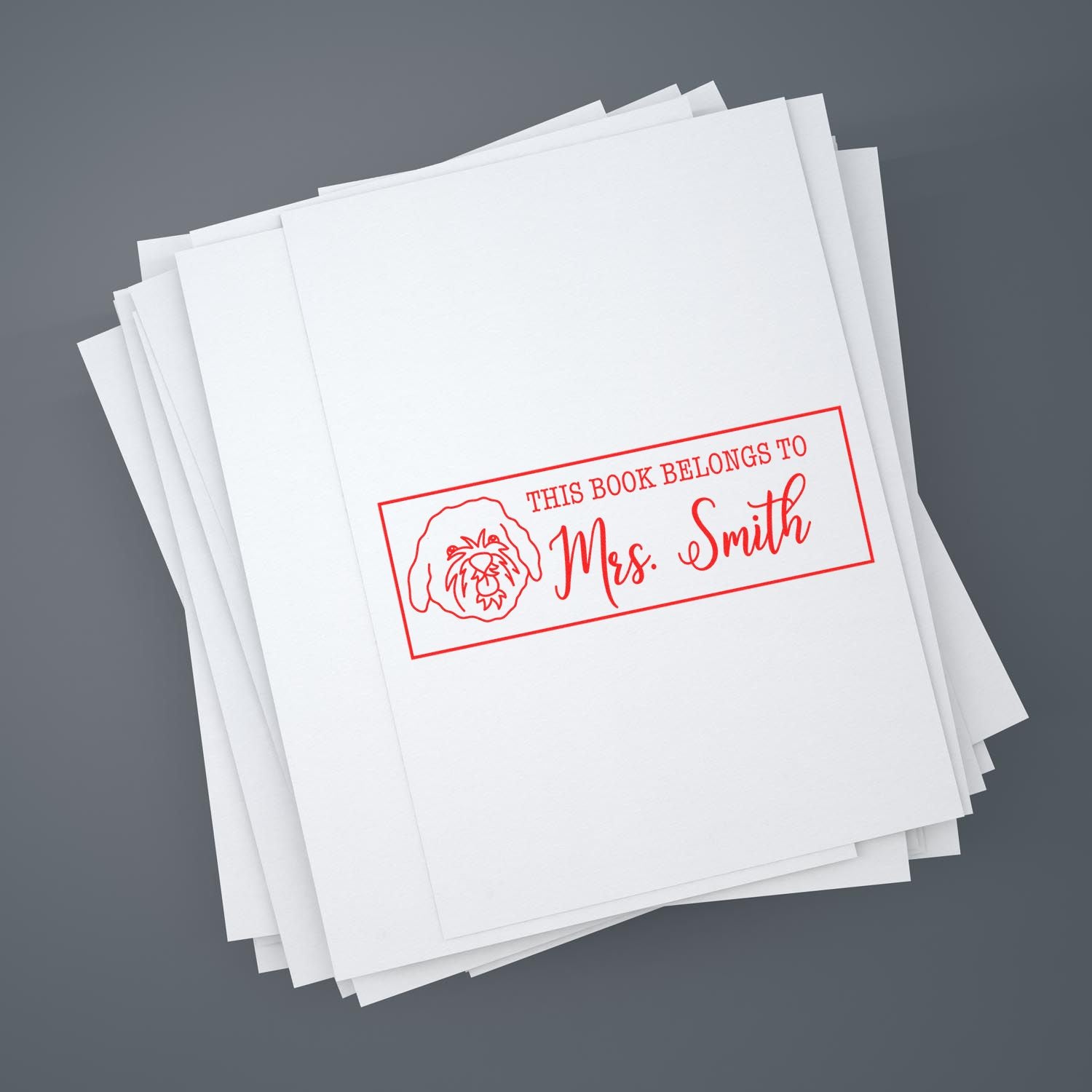 Custom rubber book stamp for Mrs. Smith with dog icon and This Book Belongs To label for personalized library marking.
