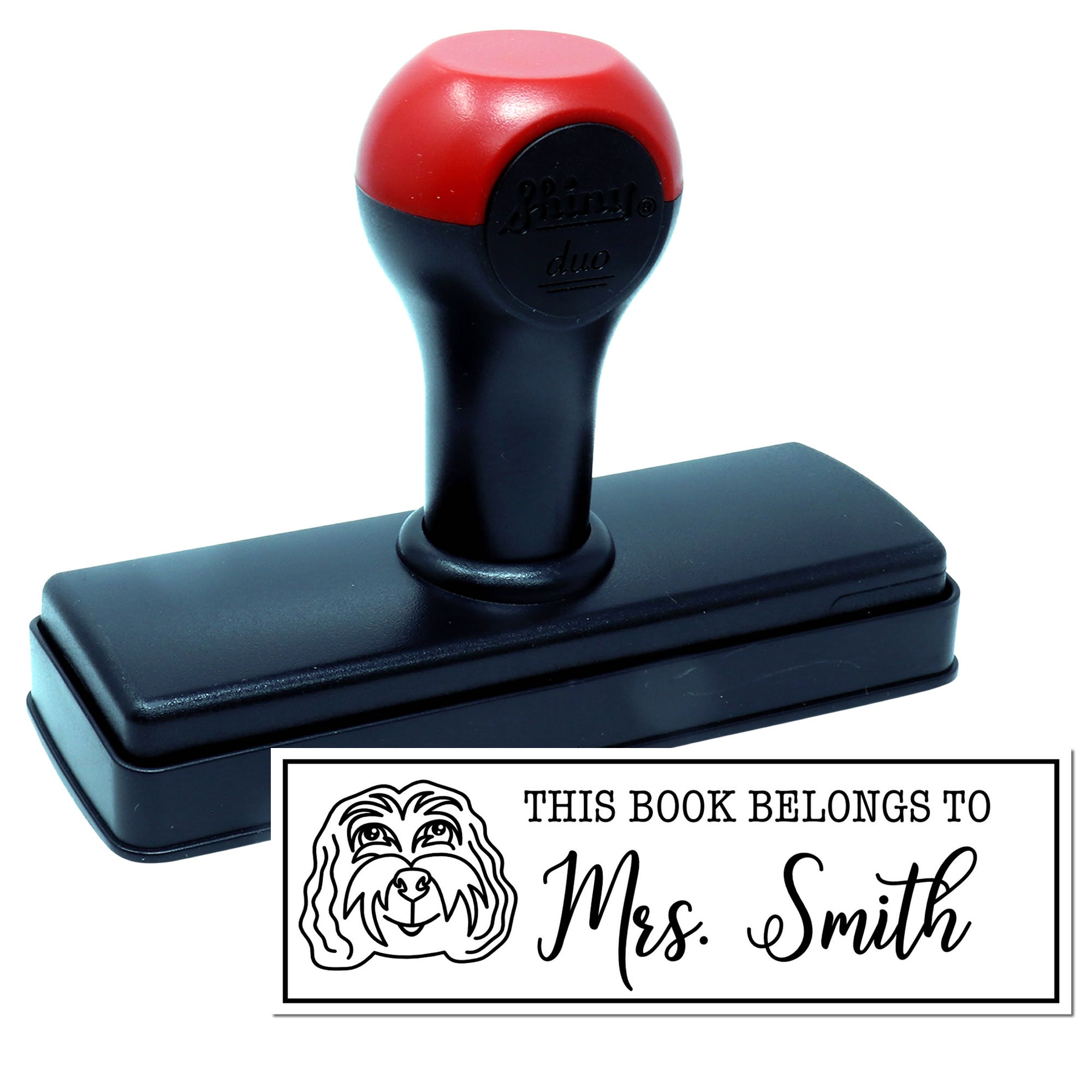 Self-inking personalized rubber book stamp with dog illustration and This Book Belongs to Mrs. Smith design