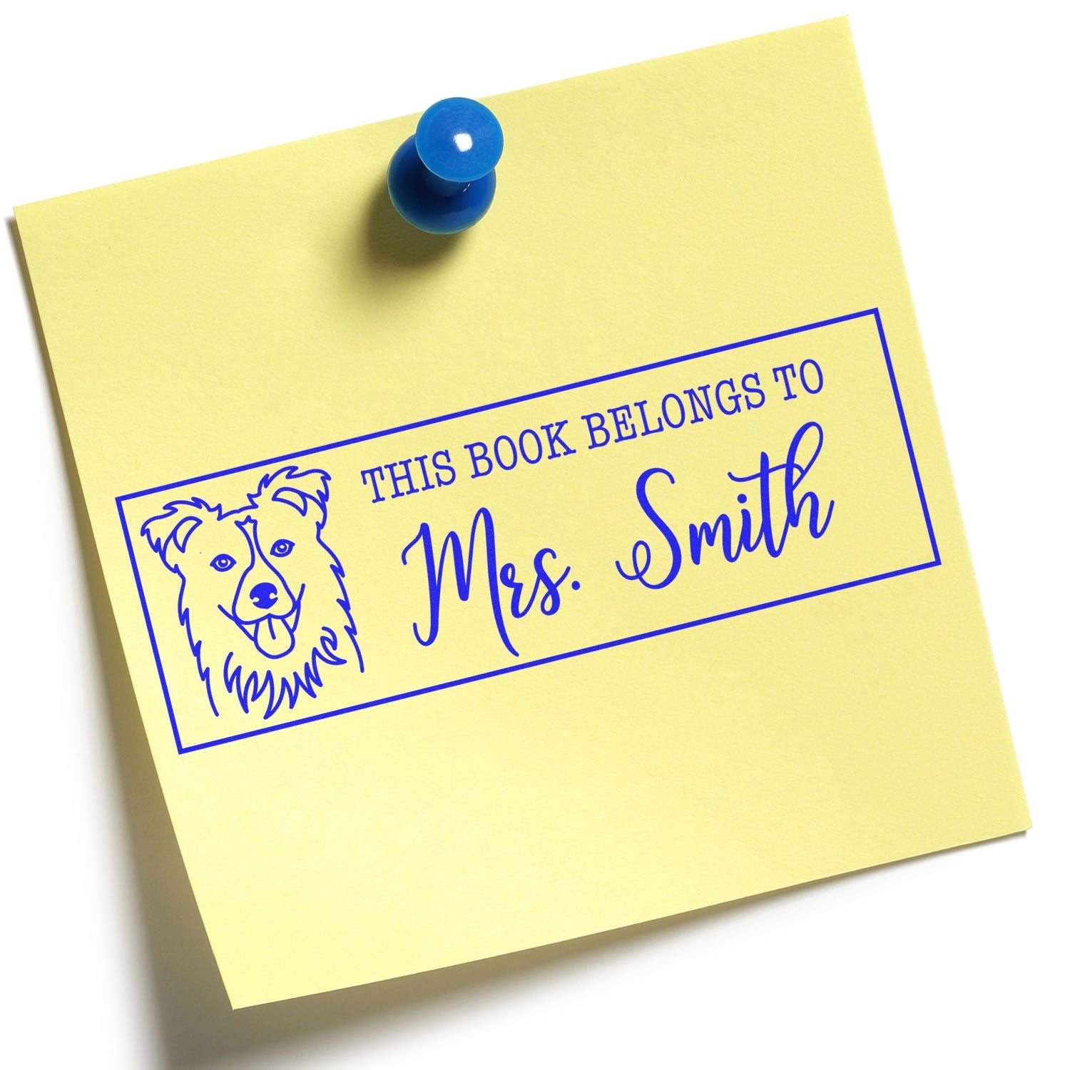 Personalized rubber book stamp with dog illustration reading This Book Belongs to Mrs. Smith for marking books.