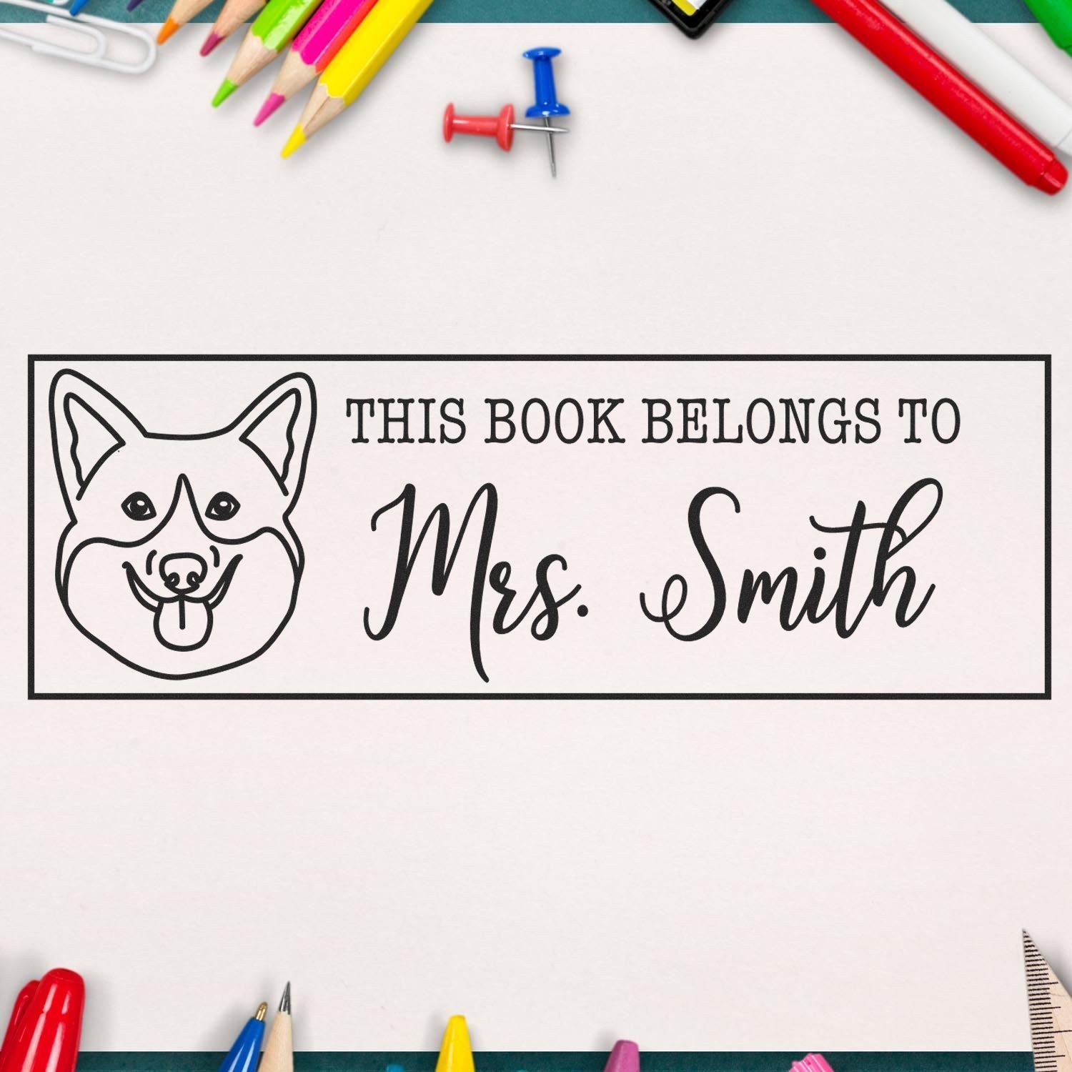 Personalized rubber book stamp with dog design and custom name, This Book Belongs To Mrs. Smith, for childrens libraries.