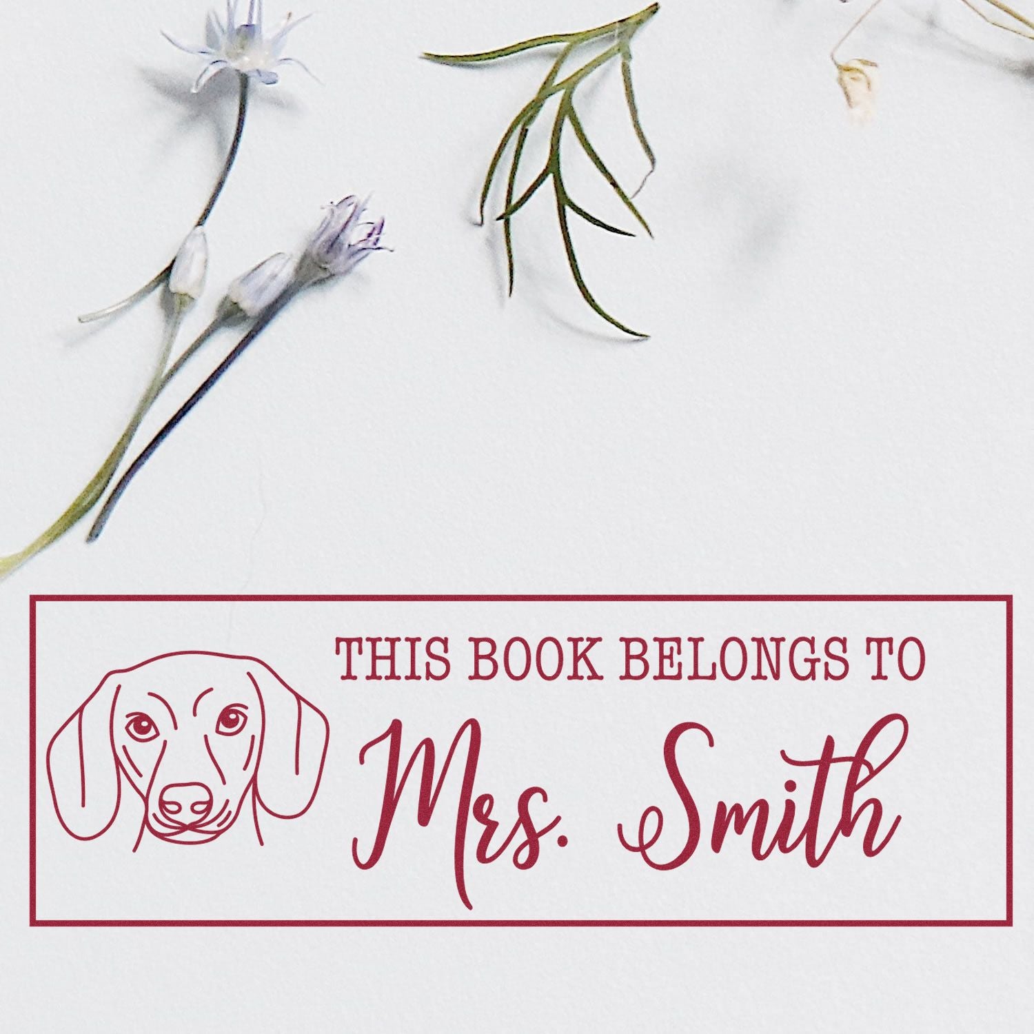 Custom book stamp with dog design and This Book Belongs to Mrs. Smith text, a personalized rubber stamp for library books.