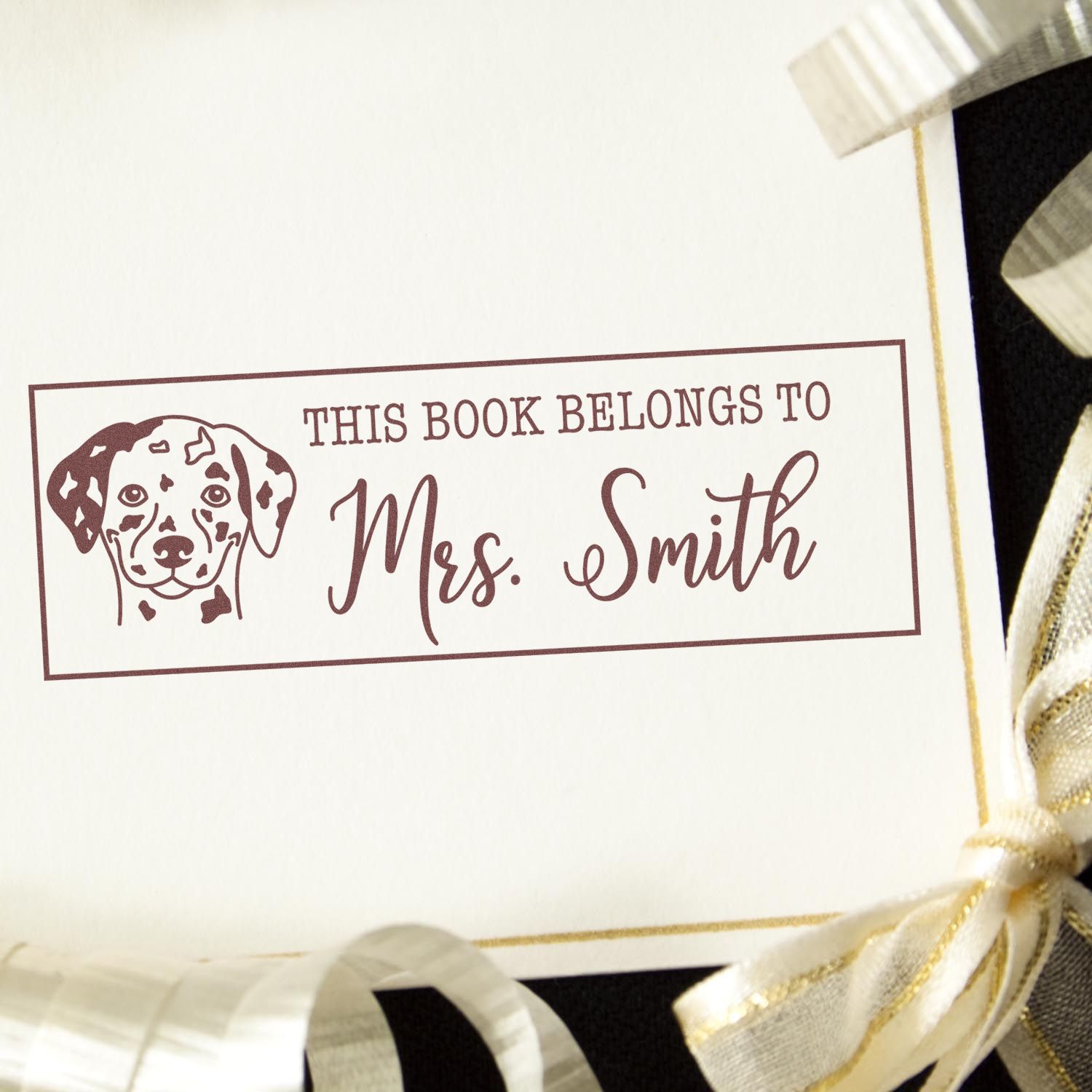 Custom book stamp with dog illustration and This Book Belongs to Mrs. Smith for personalized library books.