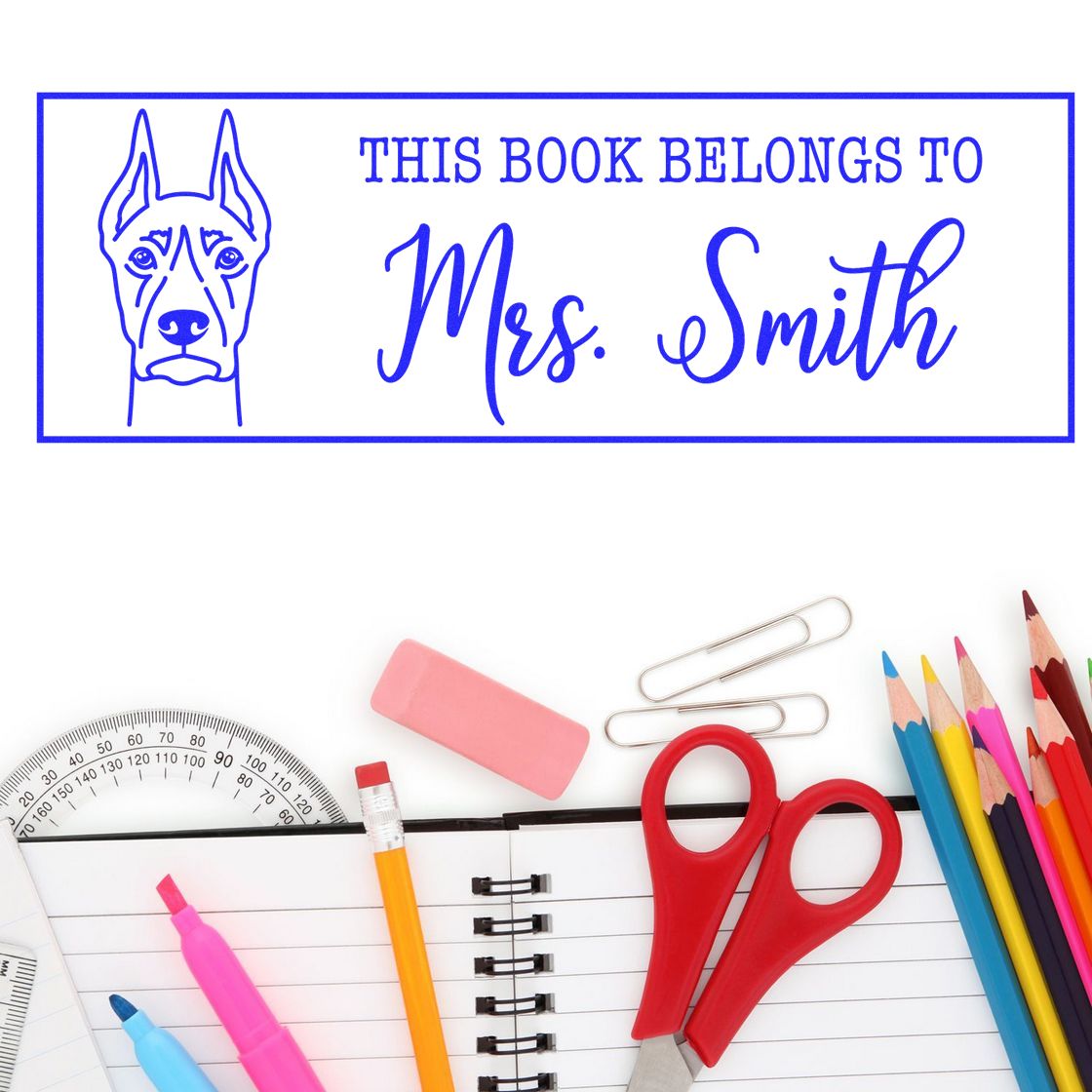 Custom rubber book stamp with dog illustration and This Book Belongs to Mrs. Smith text for personalized library labels.