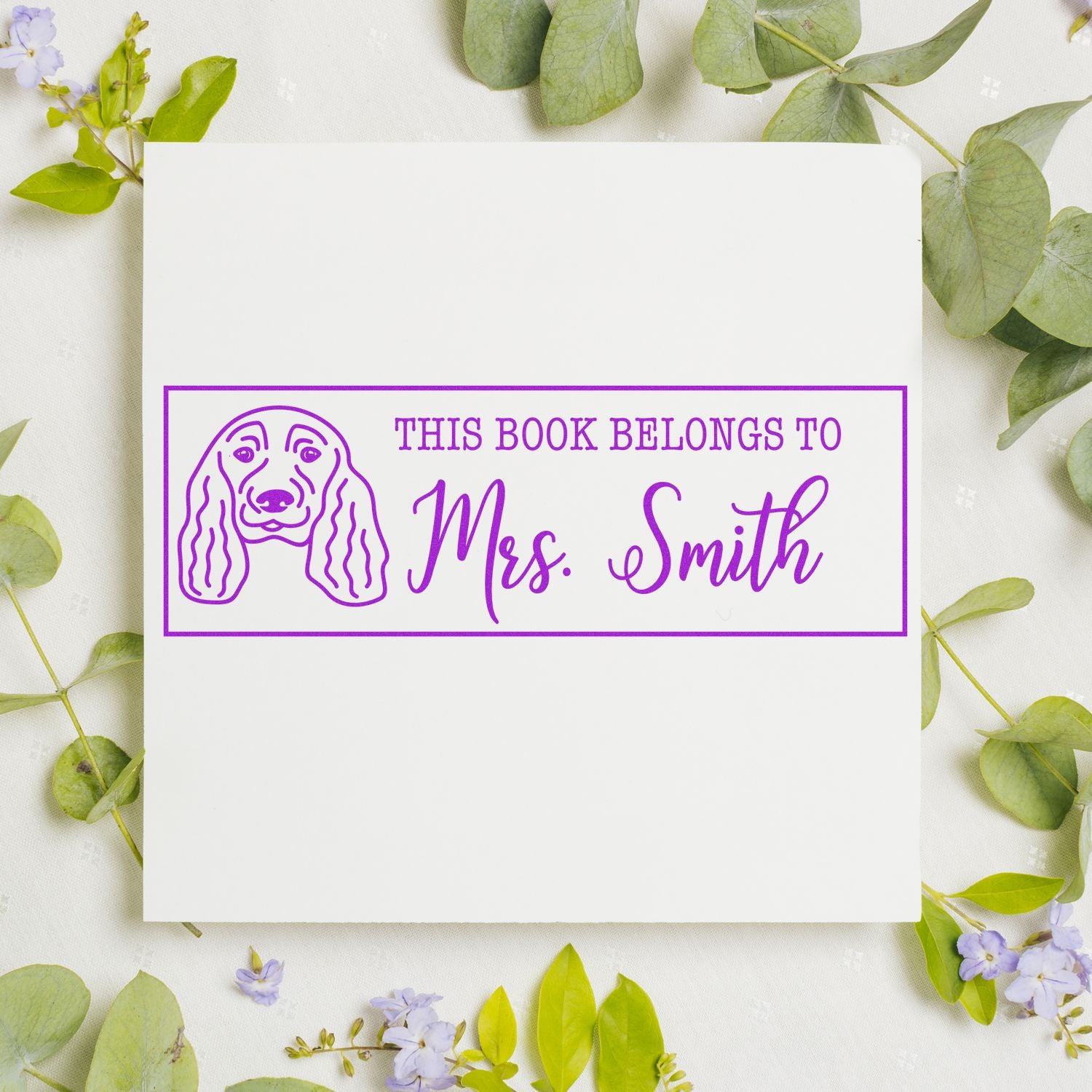 Custom dog book stamp with This Book Belongs To Mrs. Smith personalized name design in purple ink