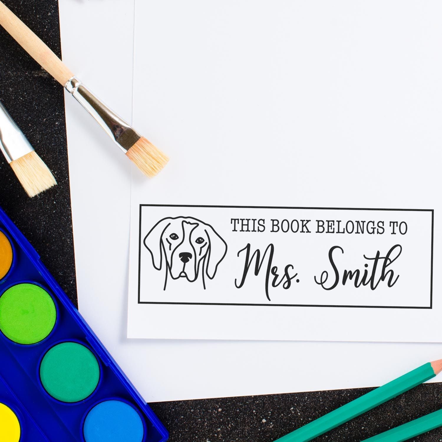 Custom rubber book stamp with dog design, personalized This Book Belongs to Mrs. Smith for teachers and readers.