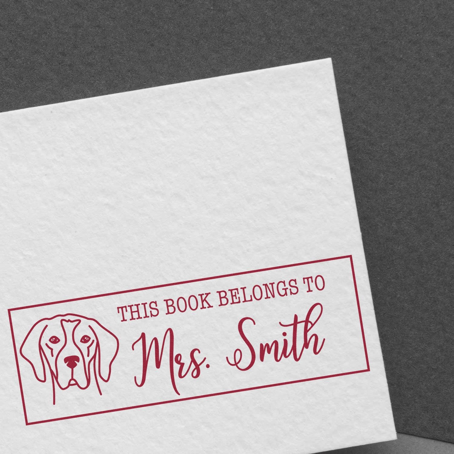 Personalized book rubber stamp for Mrs. Smith with dog design and This book belongs to library ownership mark.