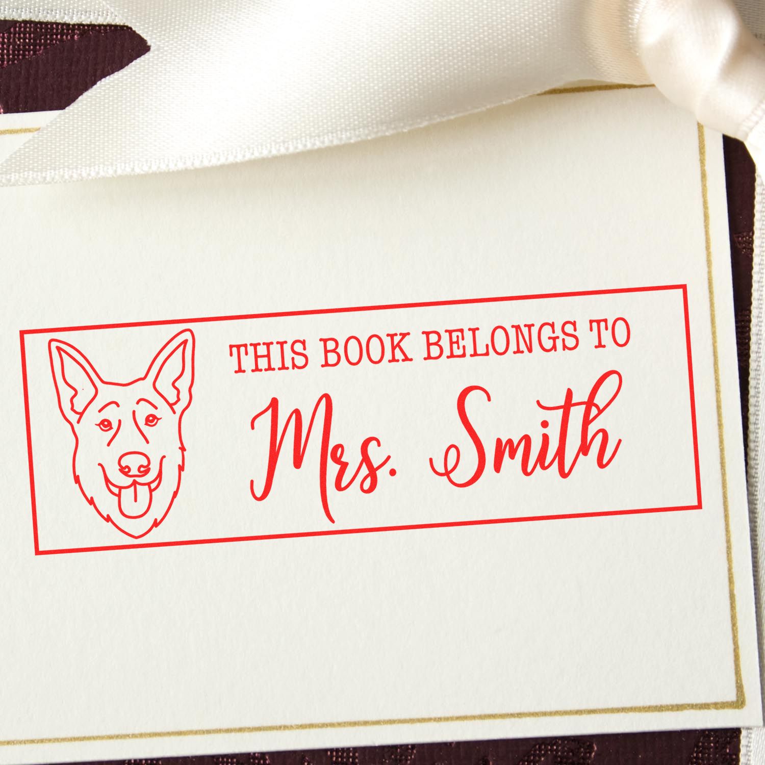 Personalized dog book stamp with custom bookplate reading This Book Belongs to Mrs. Smith for library books.