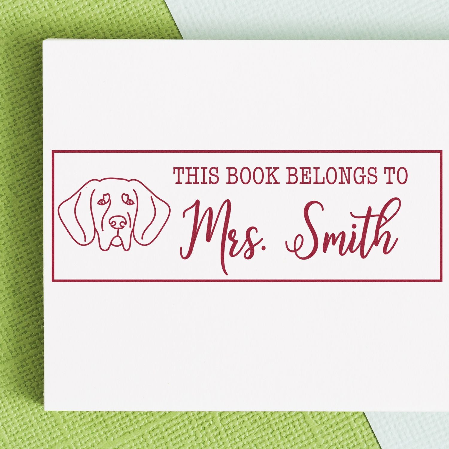 Personalized rubber stamp bookplate with dog icon and This Book Belongs to Mrs. Smith for custom library books.