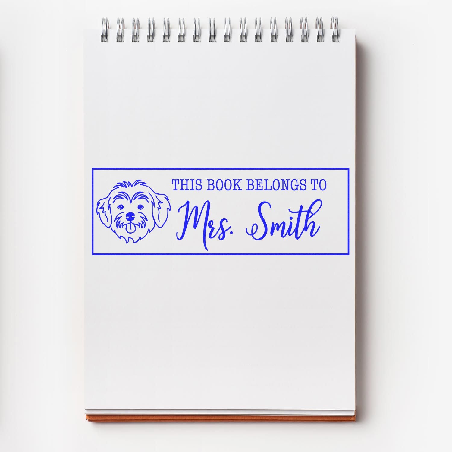 Custom rubber stamp bookplate with dog illustration and This Book Belongs to Mrs. Smith for personalized book marking.