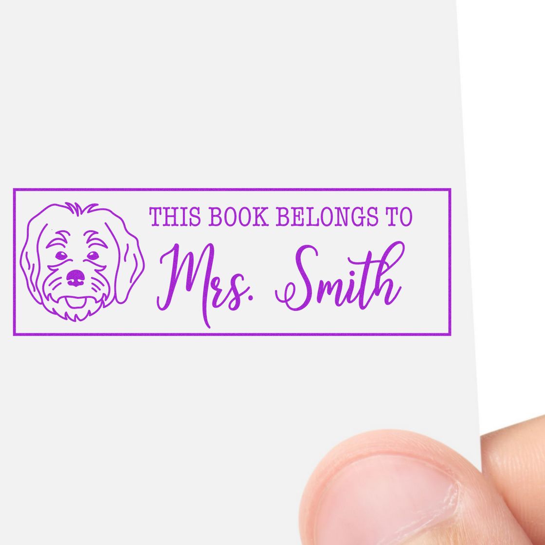 Custom dog book stamp reading This Book Belongs To Mrs. Smith for personalized library books and stationery.