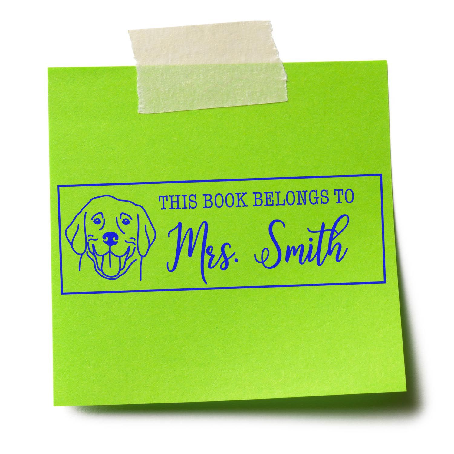 Custom rubber stamp bookplate reading This Book Belongs to Mrs. Smith with dog illustration on green note.