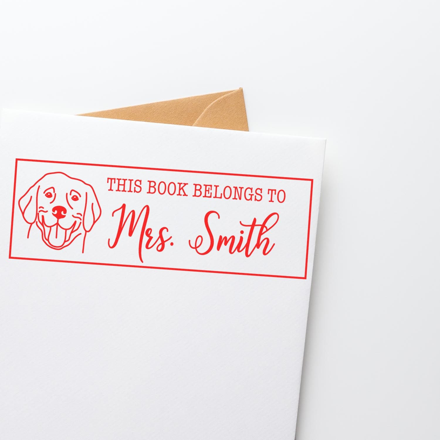 Custom book rubber stamp with dog design reading This Book Belongs to Mrs. Smith for personalized library books.