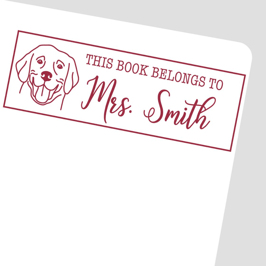 Custom dog book stamp reading This Book Belongs to Mrs. Smith for personalized library books and ex libris marking.