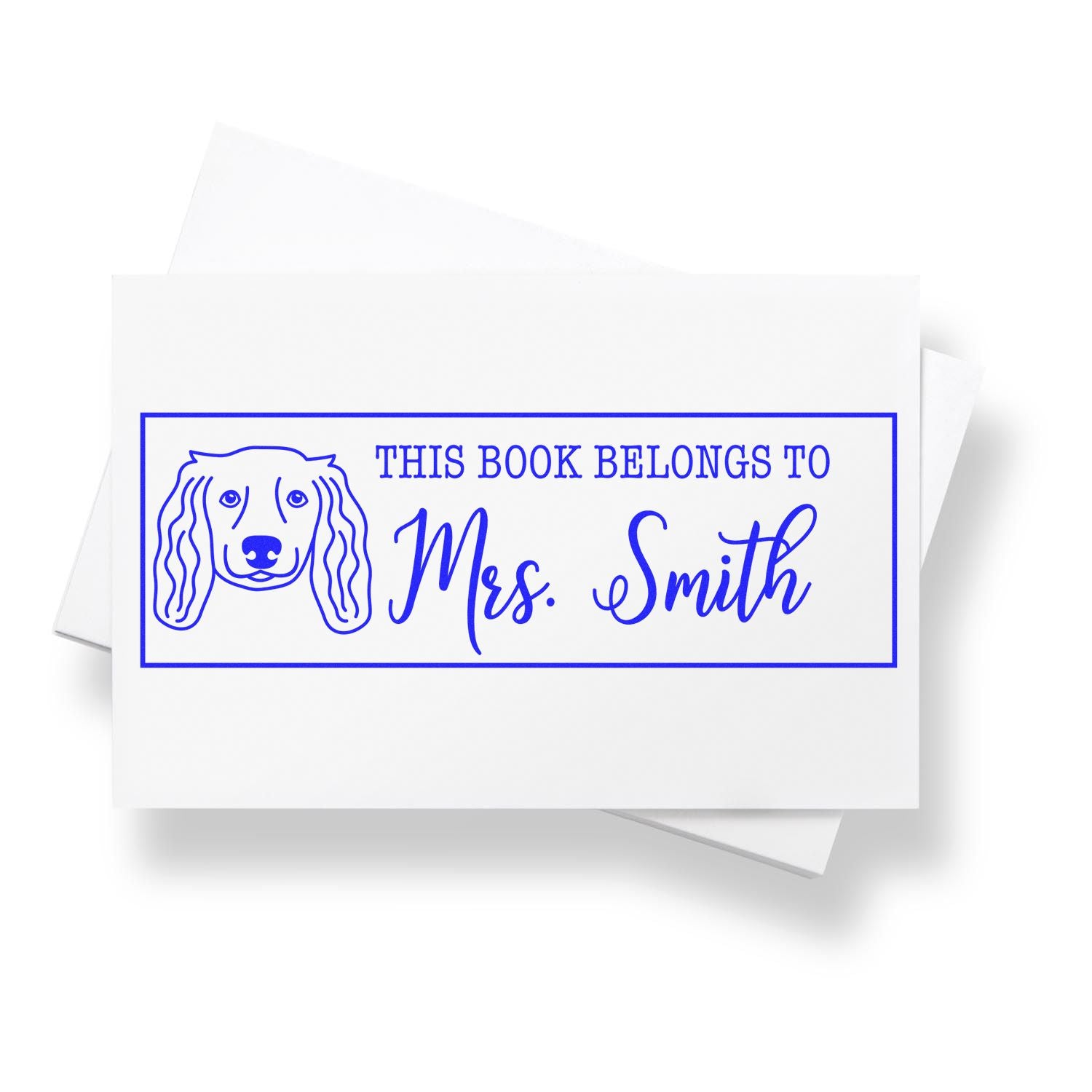 Personalized dog-themed bookplate stamp reading This Book Belongs to Mrs. Smith for labeling books and library collections.
