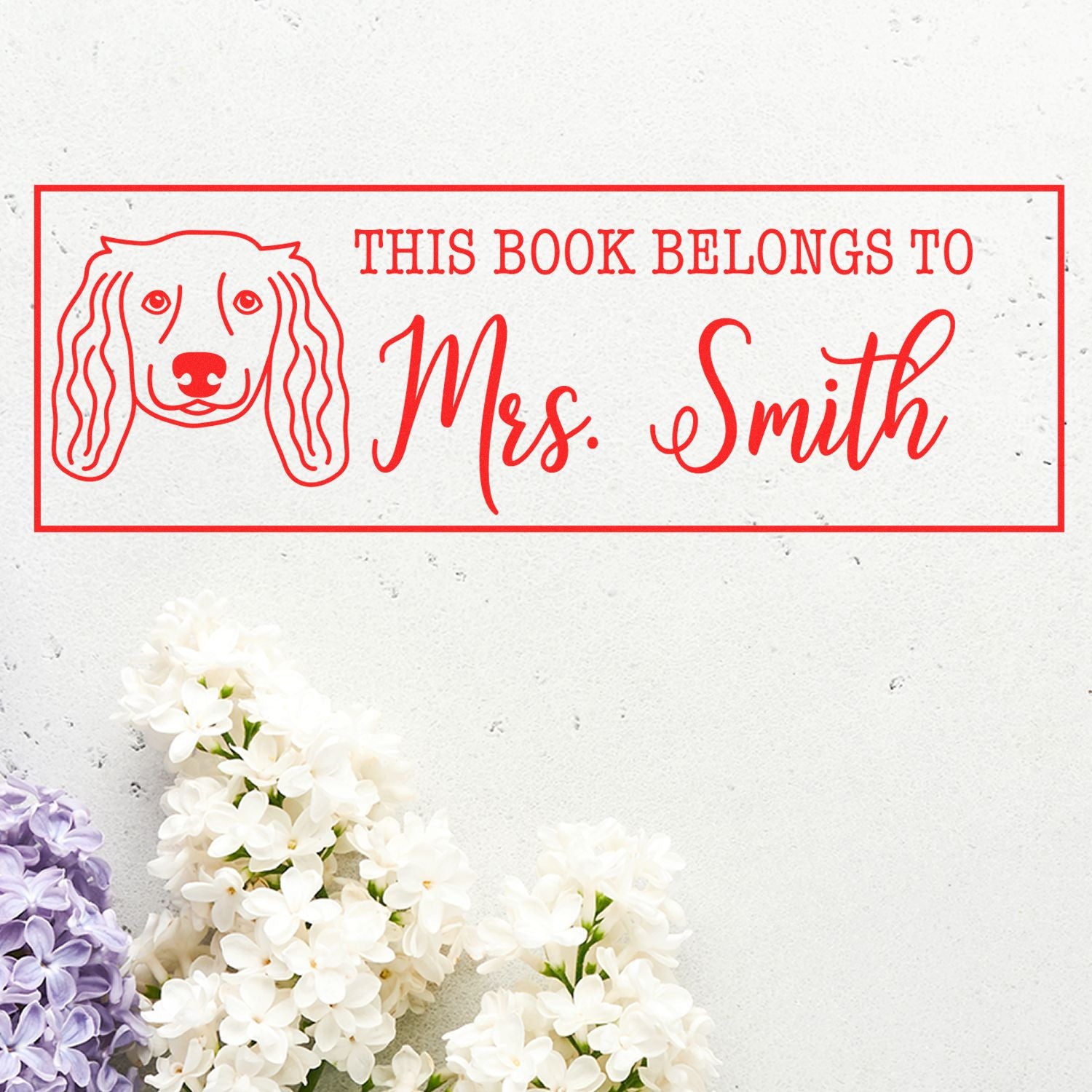 Personalized dog-themed rubber stamp reading This Book Belongs to Mrs. Smith for custom book ownership labels.