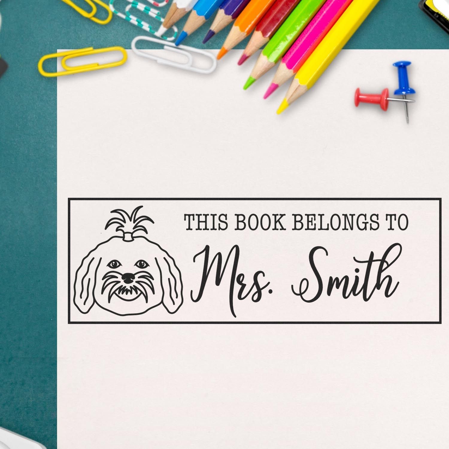 Personalized rubber stamp reading This Book Belongs to Mrs. Smith with dog design, ideal for book labels and classroom use.