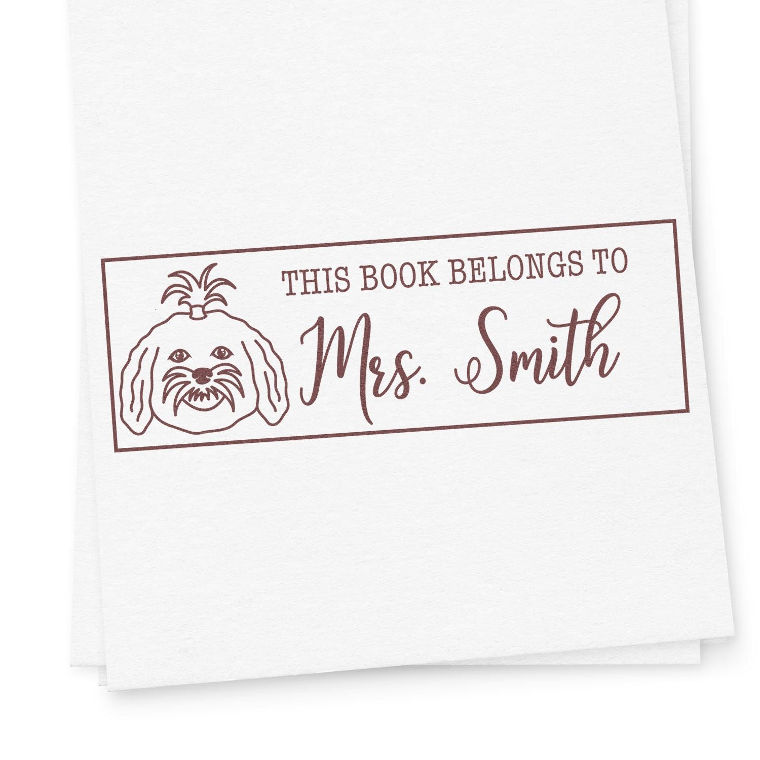 Personalized book rubber stamp with dog illustration and This Book Belongs to Mrs. Smith text for custom library labels.
