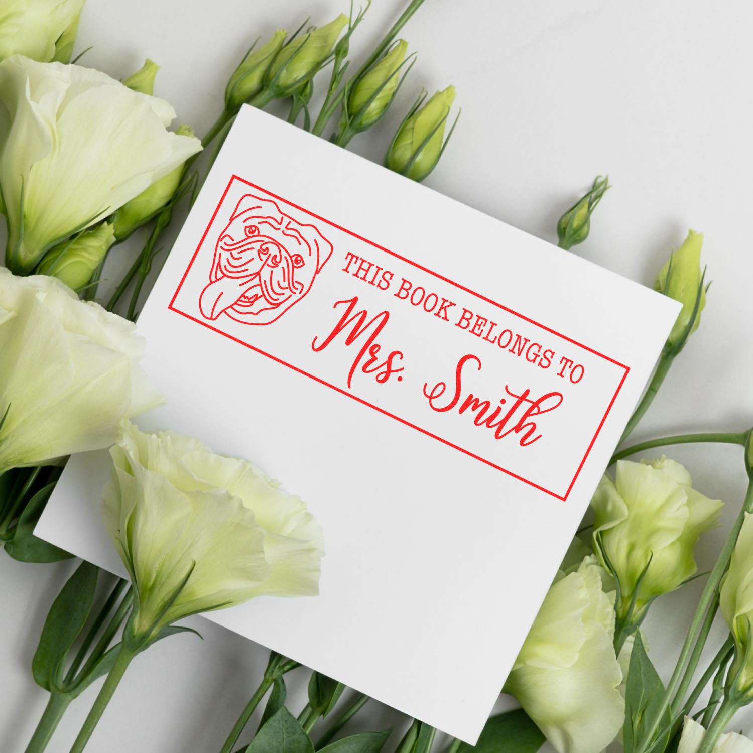 Custom personalized bookplate rubber stamp with dog illustration, reading This Book Belongs to Mrs. Smith.