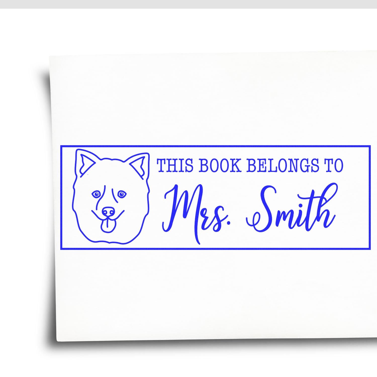 Custom dog book stamp with This Book Belongs To Mrs. Smith for personalized library marking.