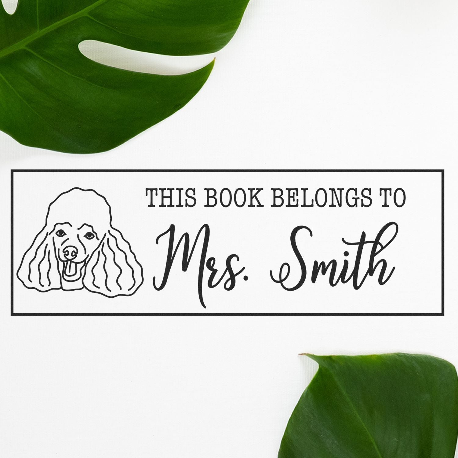 Personalized bookplate rubber stamp with poodle illustration and This Book Belongs to Mrs. Smith text.
