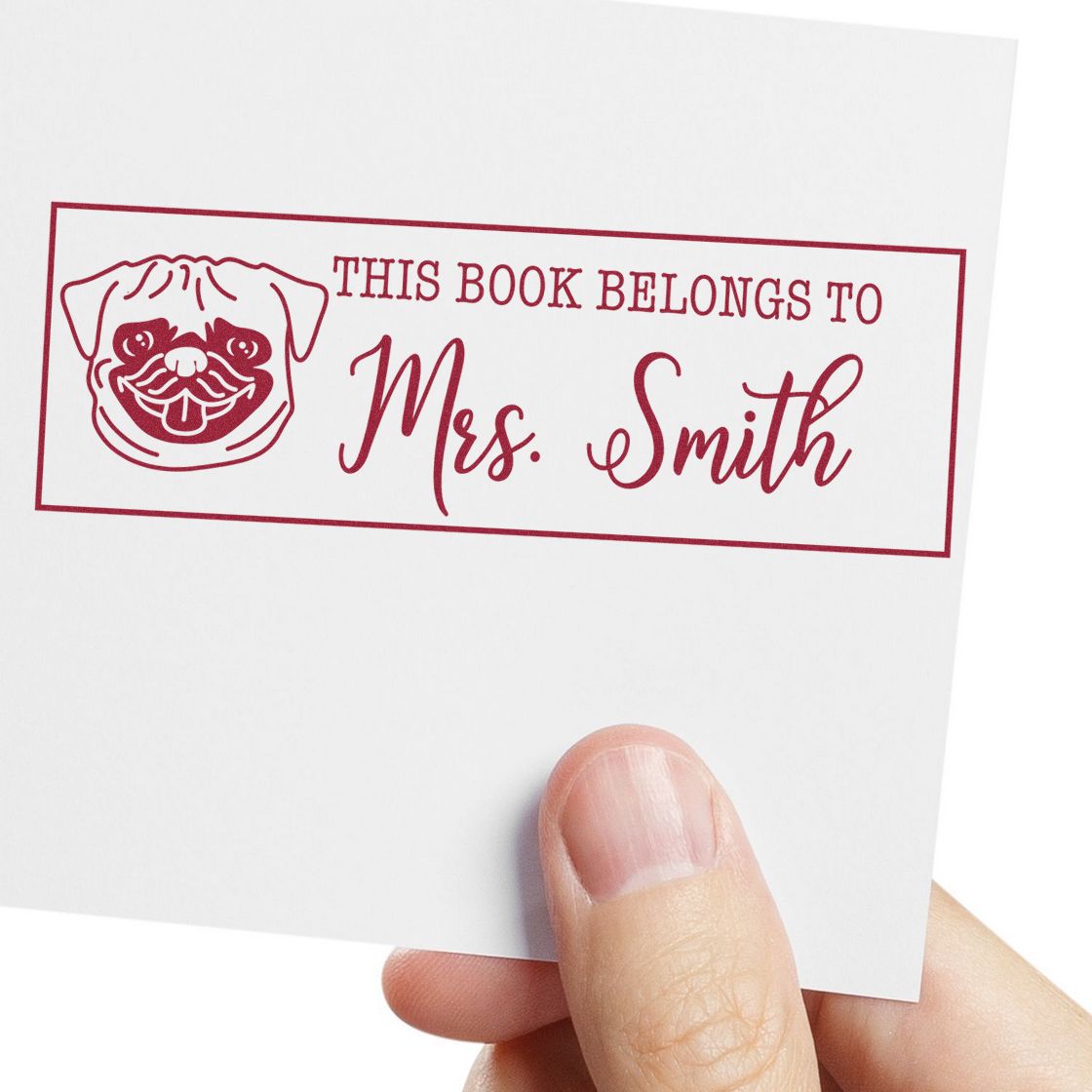 Custom rubber stamp reading This Book Belongs to Mrs. Smith with pug design for personal library book labeling.