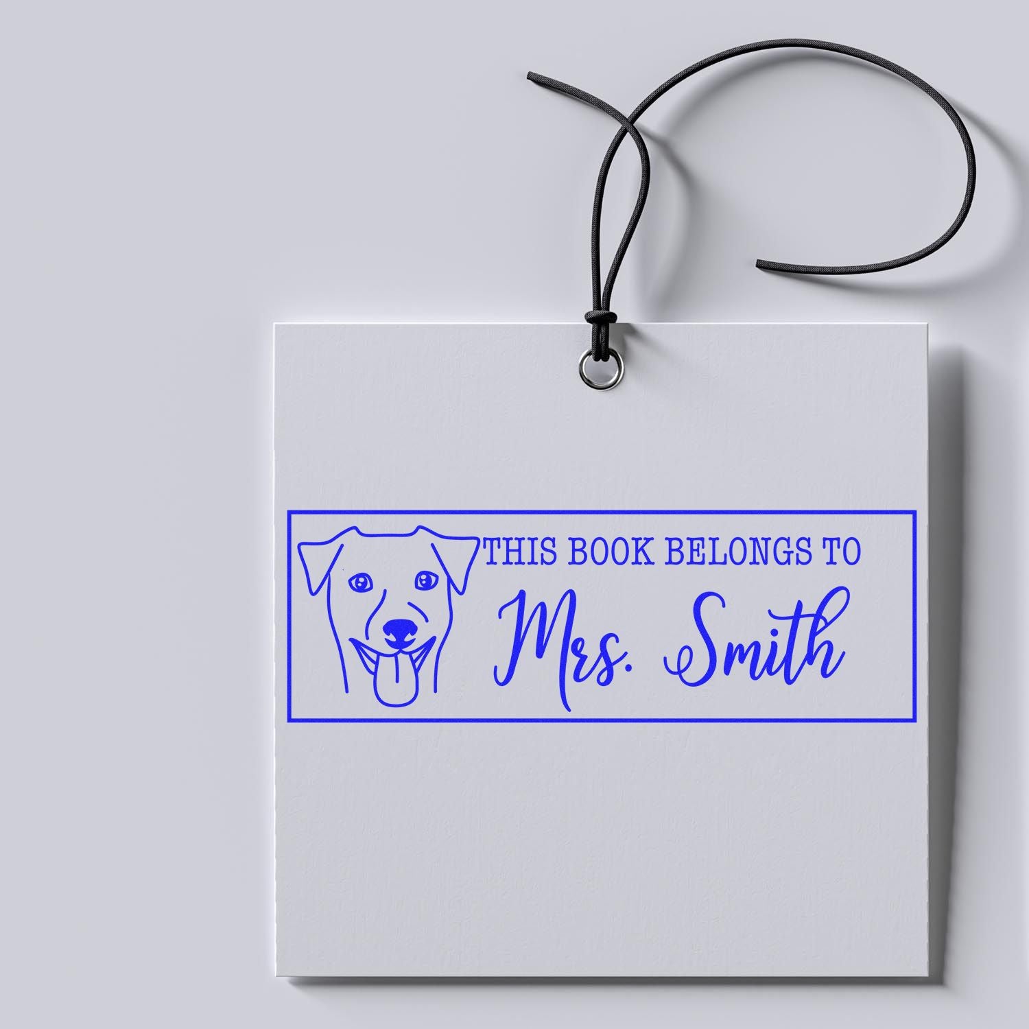 Personalized dog book rubber stamp reading "This Book Belongs to Mrs. Smith" for custom library and classroom books.