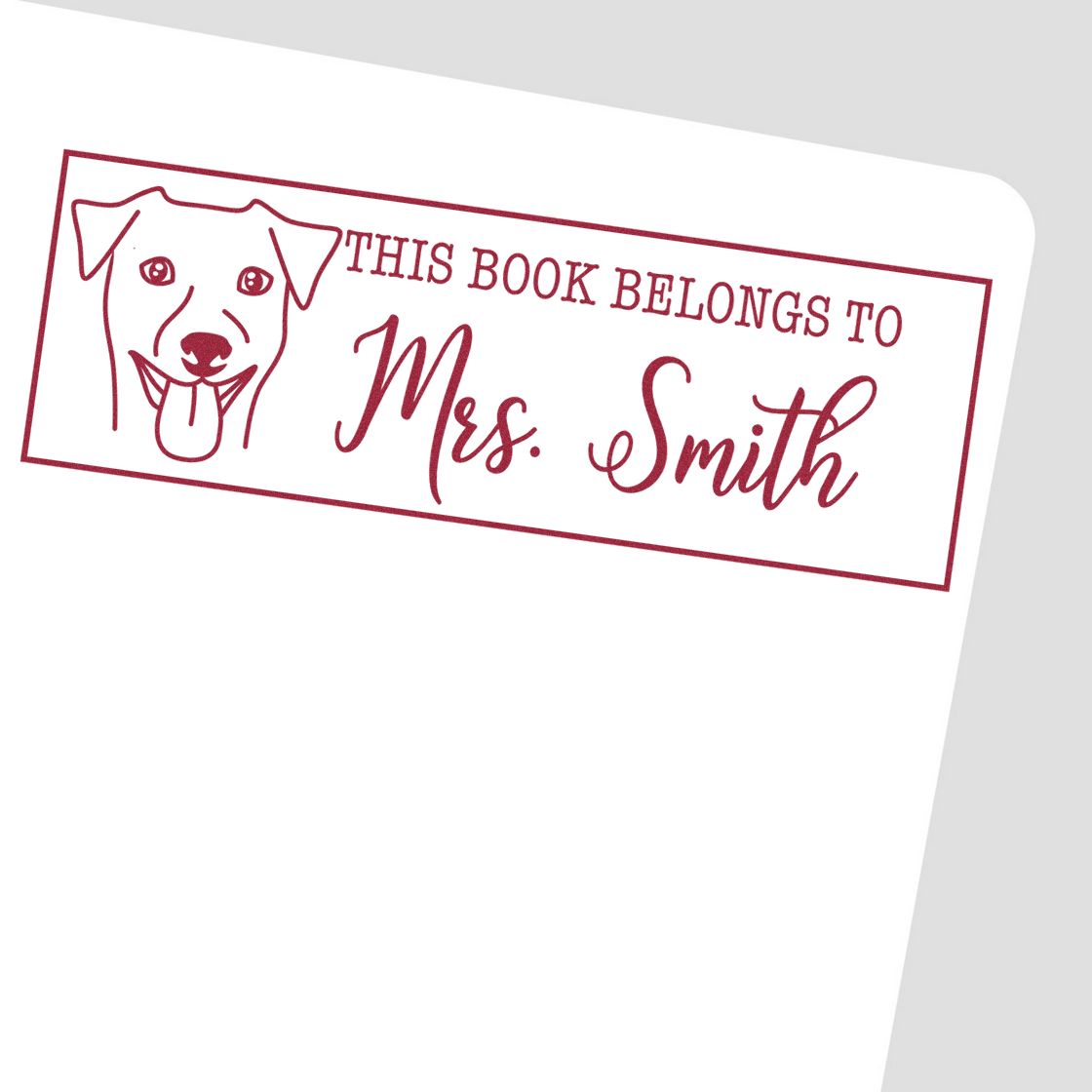 Custom rubber stamp bookplate reading This Book Belongs to Mrs. Smith with a dog illustration for personalized books.