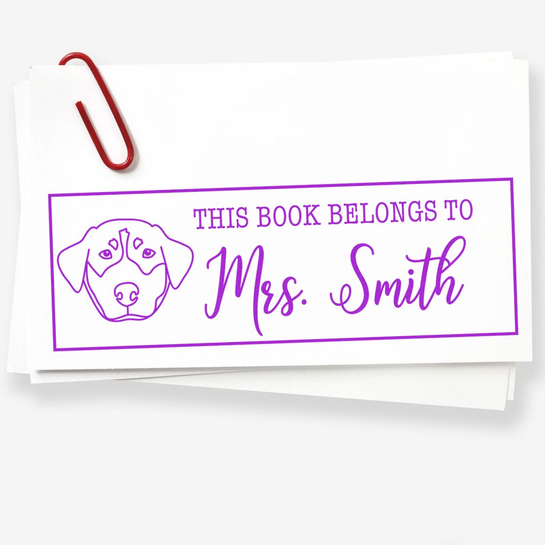 Personalized book stamp with dog design and This Book Belongs to Mrs. Smith text for custom library labeling.