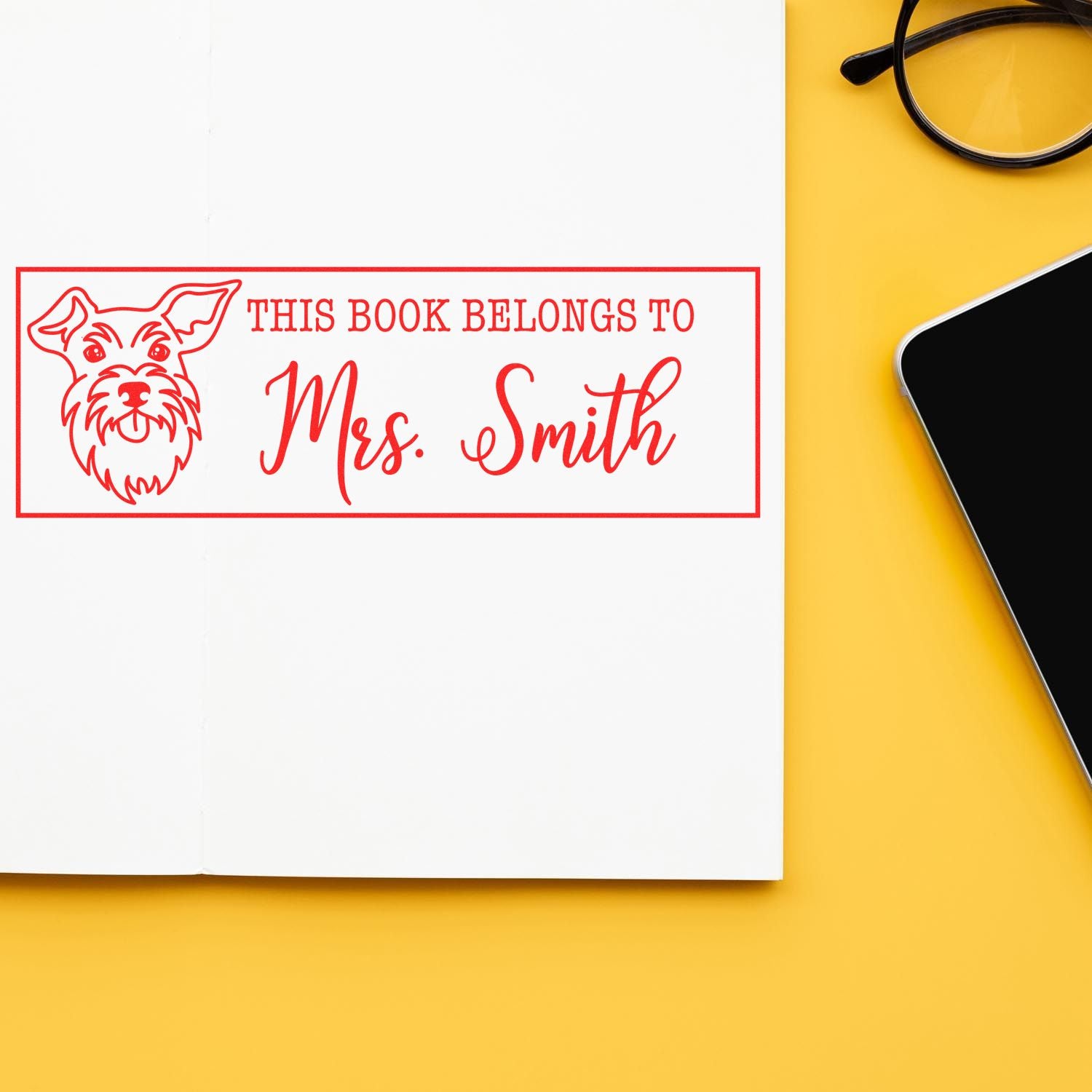 Custom rubber book stamp with dog illustration and This book belongs to Mrs. Smith for personalized library books.