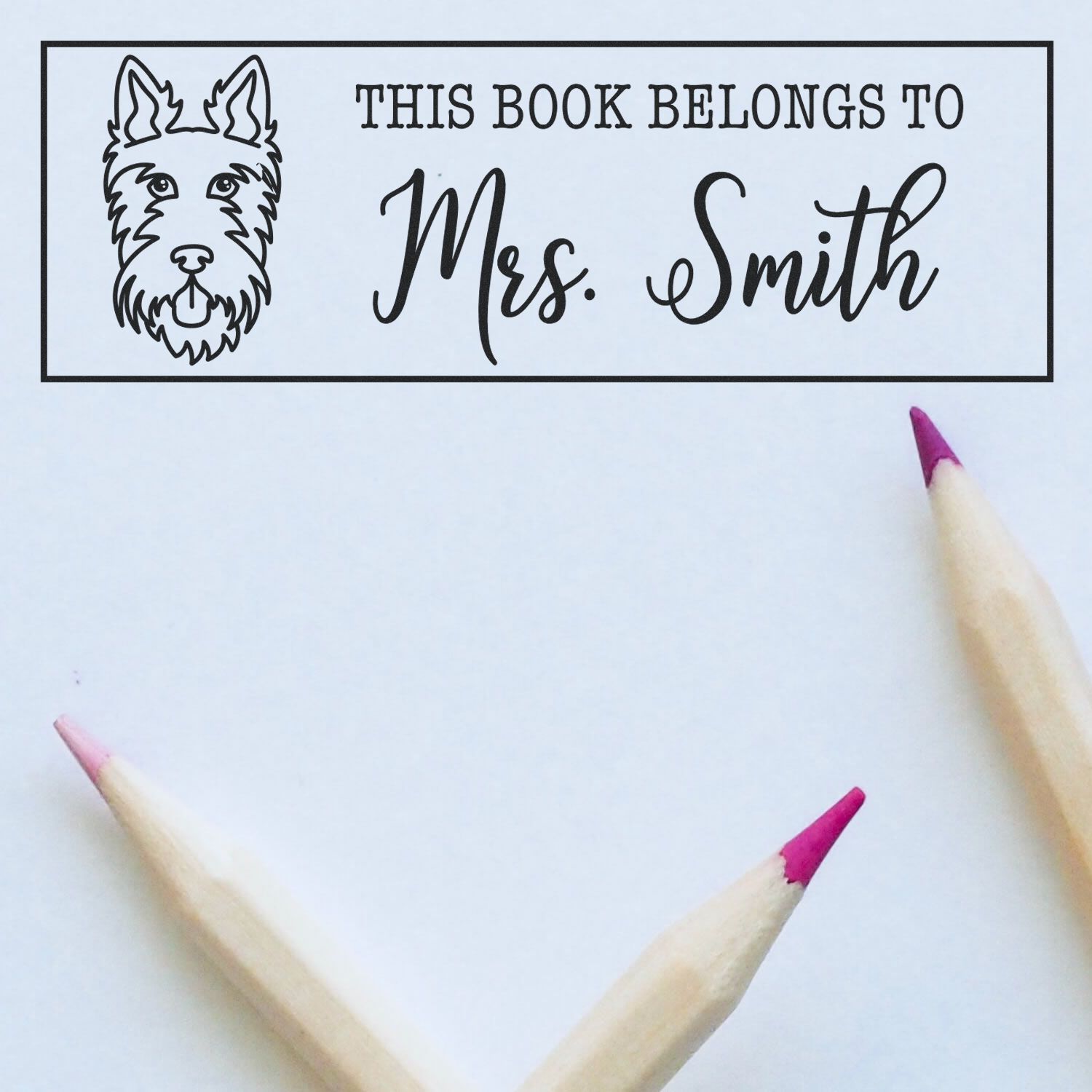 Personalized book ownership rubber stamp with dog design and This Book Belongs to Mrs. Smith for library books.