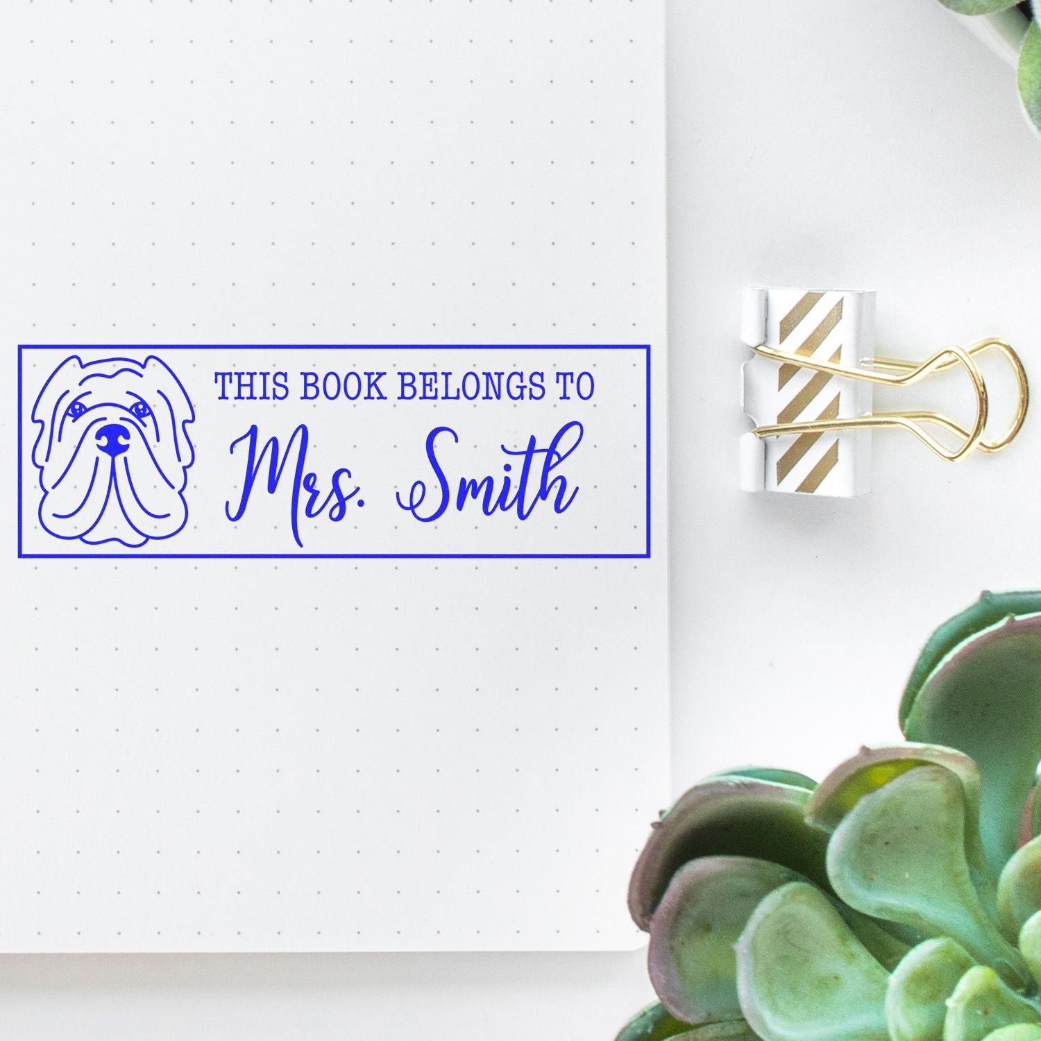 Custom rubber book stamp with dog design and This Book Belongs to Mrs. Smith text for personal library marking.
