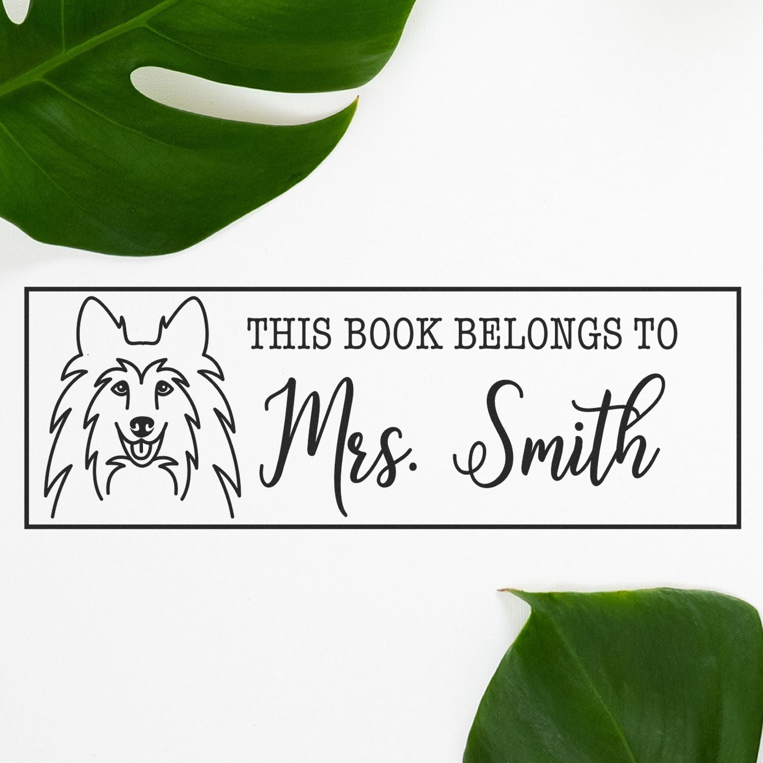 Custom dog book stamp reading This Book Belongs to Mrs. Smith for personalized library books and teacher gifts.