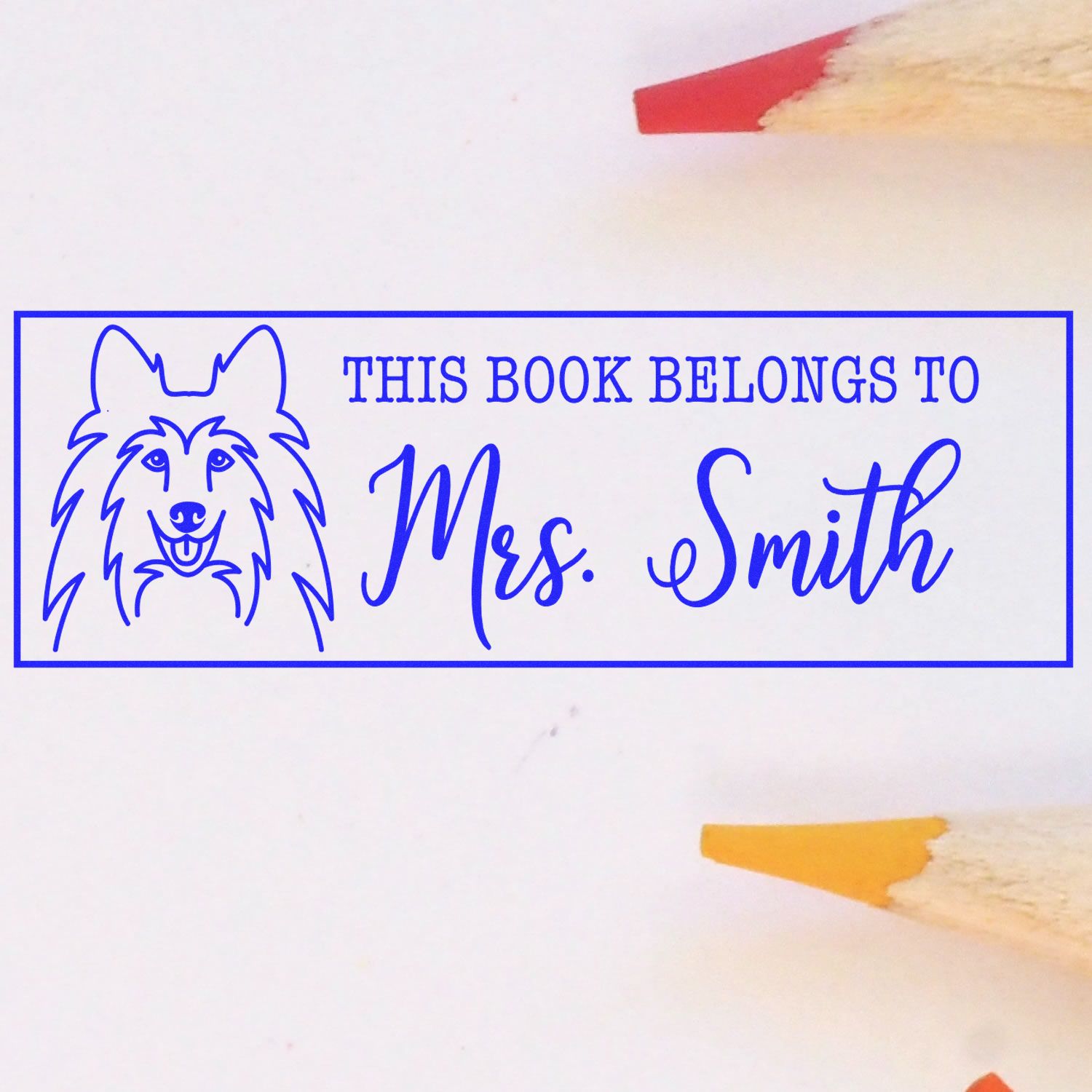 Personalized rubber stamp for books with dog design and This Book Belongs To Mrs. Smith text for library use.