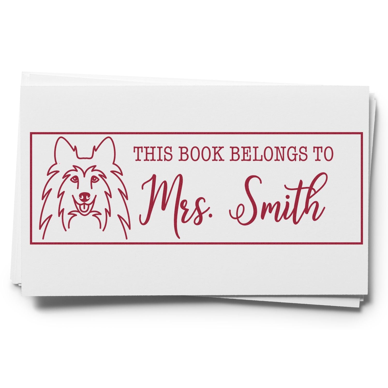 Custom rubber book stamp with dog illustration and personalized This Book Belongs to Mrs. Smith bookplate design.