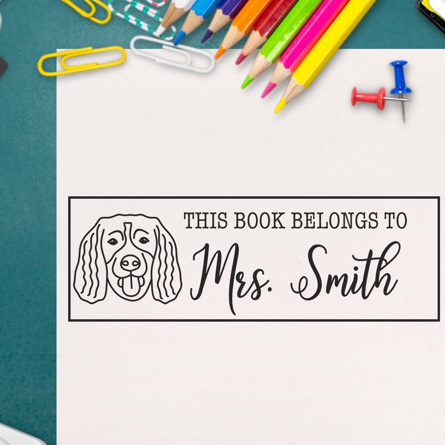 Custom dog-themed bookplate rubber stamp reading This Book Belongs to Mrs. Smith for teachers, libraries, and book lovers.