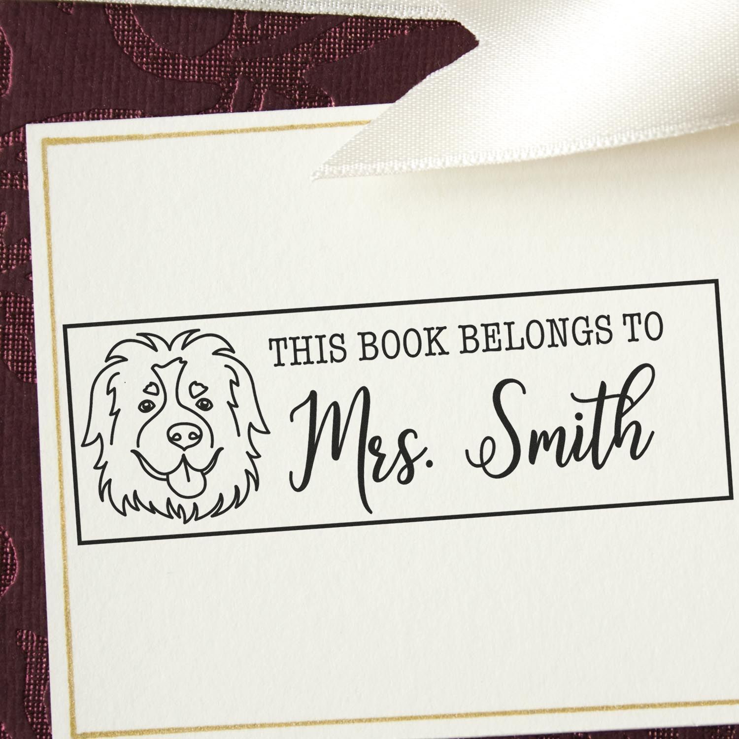Custom rubber book stamp with dog illustration and This book belongs to Mrs. Smith for personalized library books.