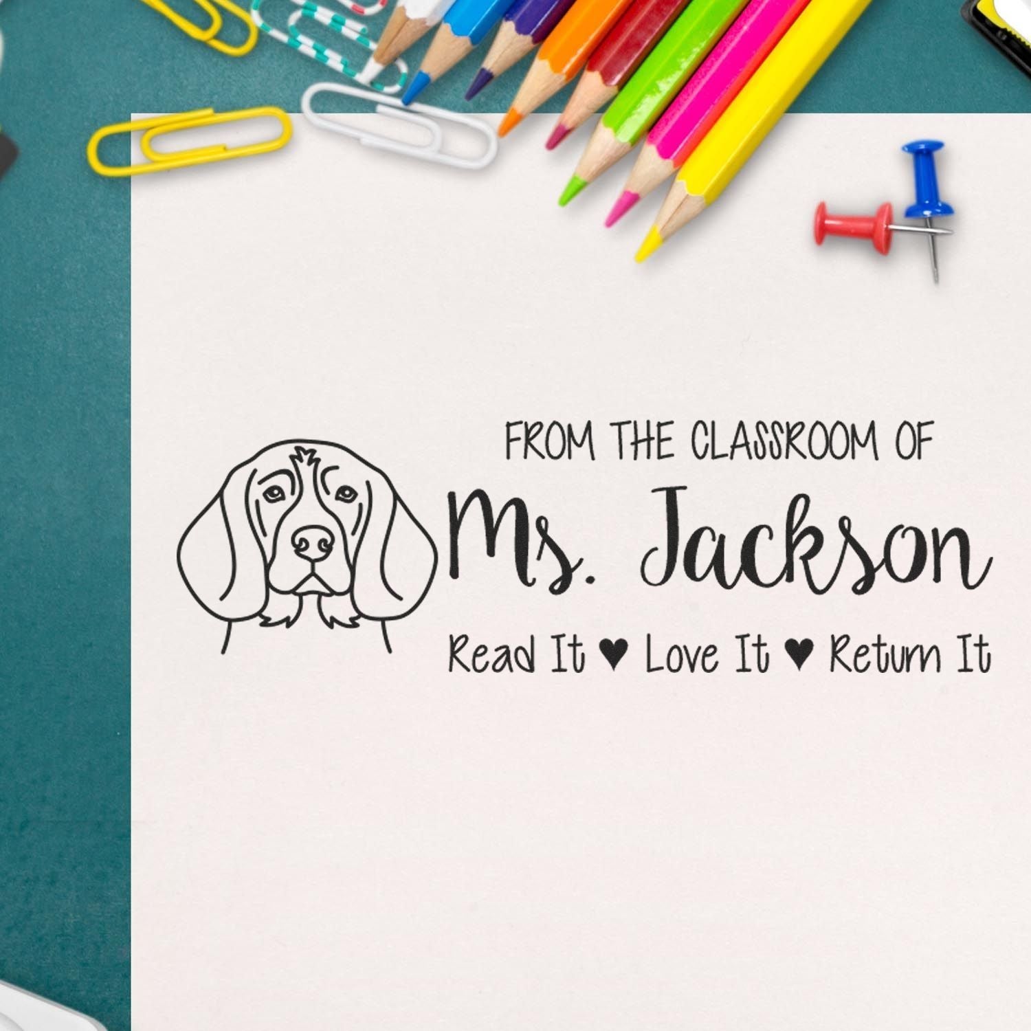 Custom teacher rubber stamp with dog illustration and Read It Love It Return It classroom book stamp for Ms. Jackson.