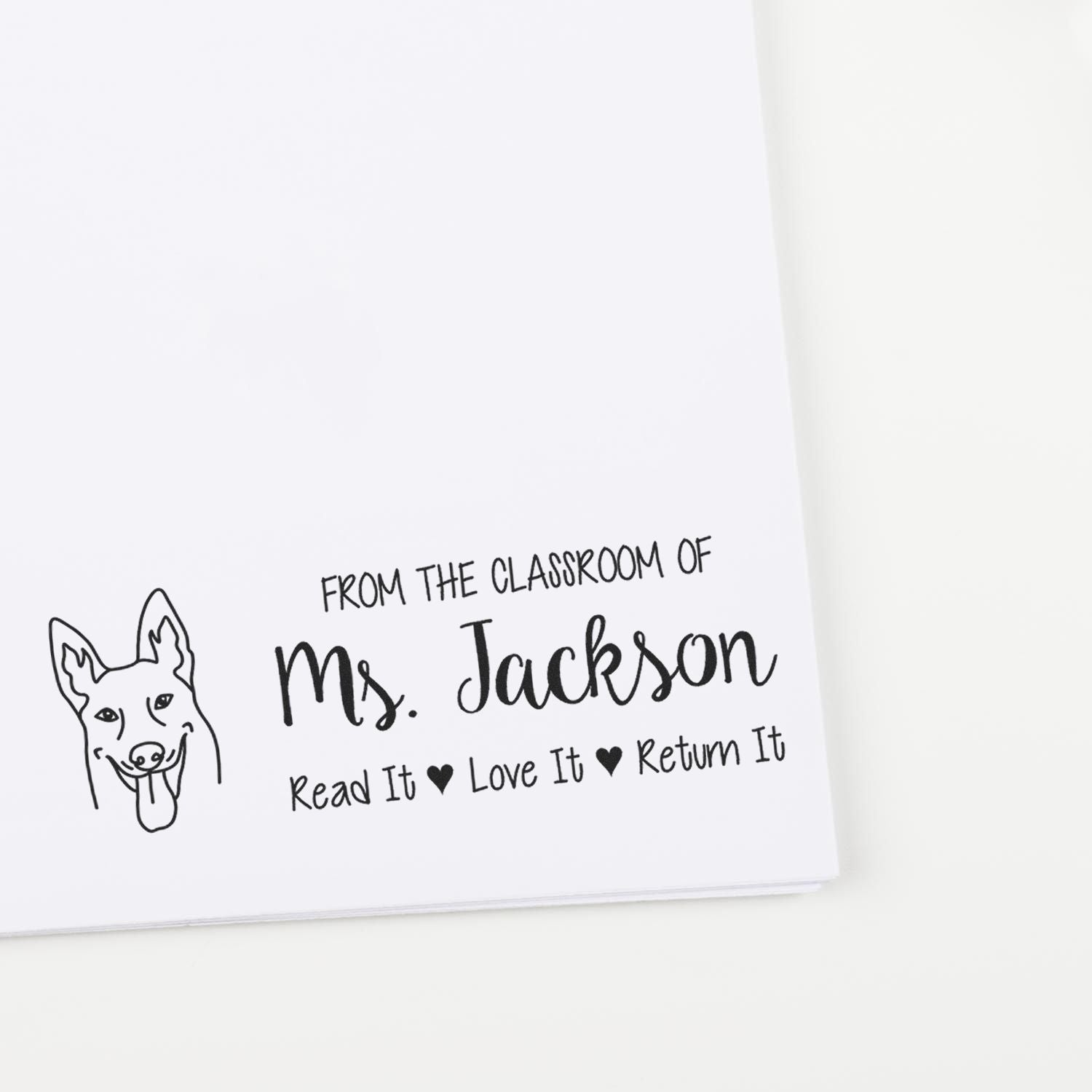 Custom teacher rubber stamp with dog icon and From the classroom of Ms. Jackson Read It, Love It, Return It book label.