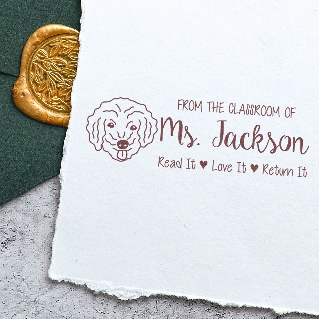 Custom classroom library rubber stamp for Ms. Jackson with dog icon and Read It, Love It, Return It book label.