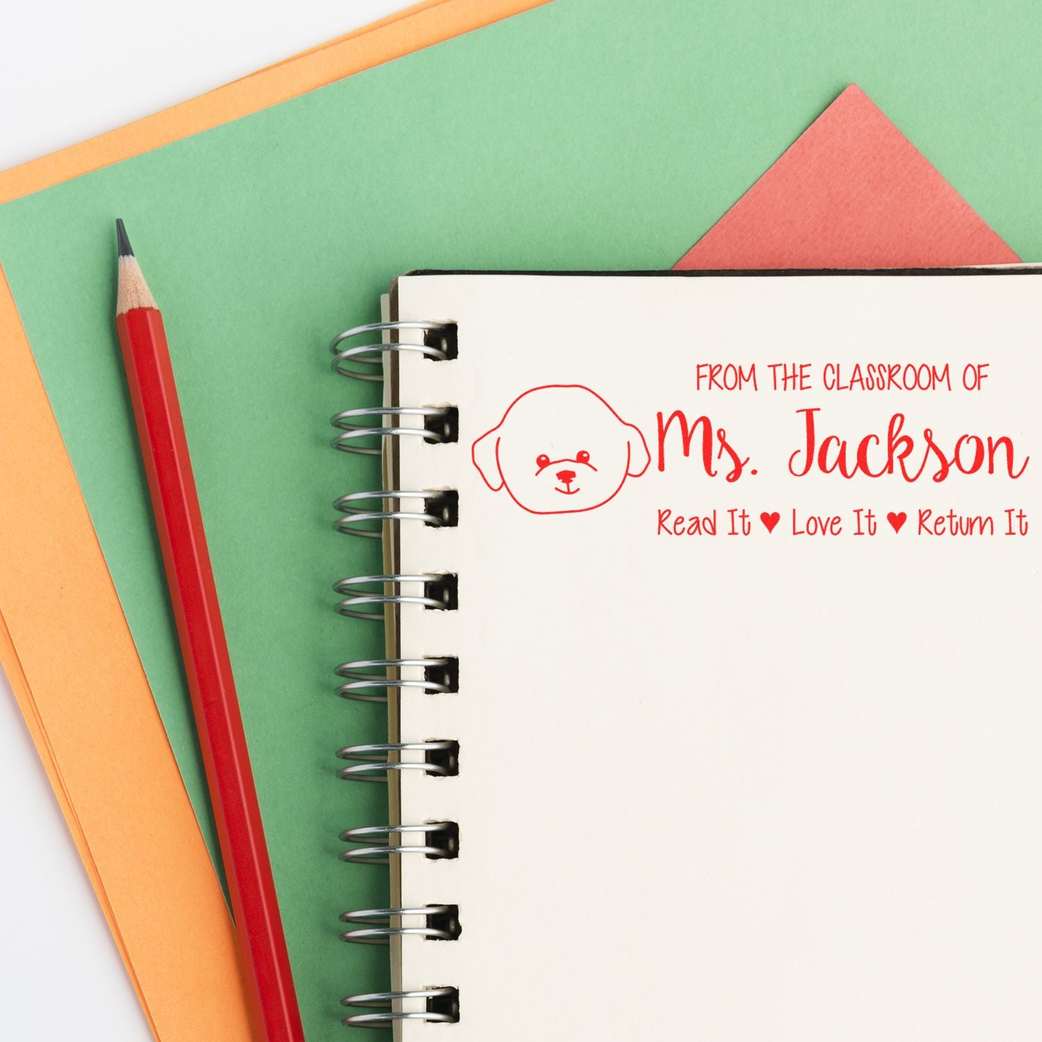 Personalized teacher rubber stamp on notebook: From the Classroom of Mrs. Jackson, Read It Love It Return It book label.