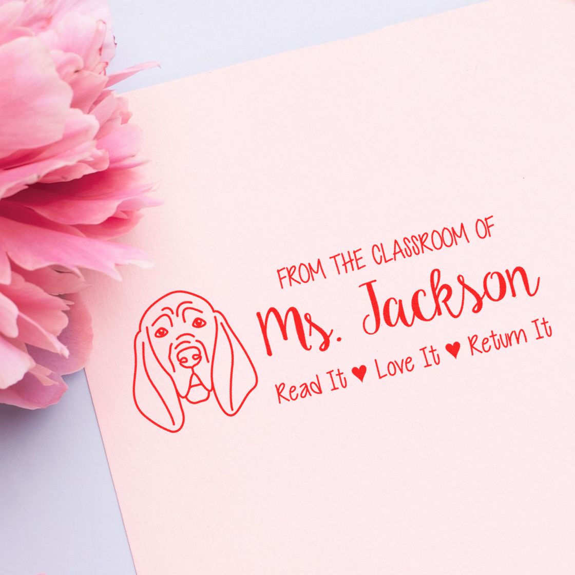 Custom classroom rubber stamp for Mrs. Jackson, featuring dog artwork and a Read It, Love It, Return It bookplate.